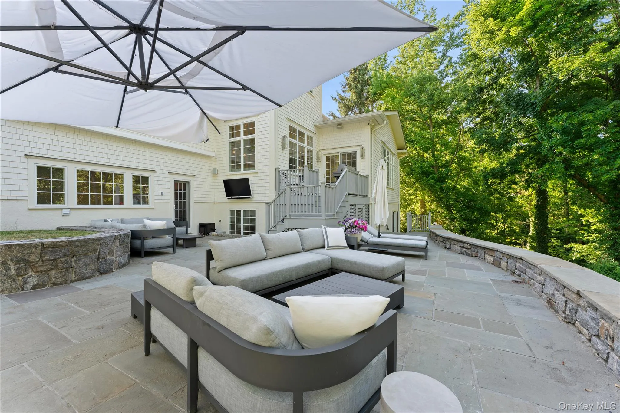 Fabulous bluestone patio with stone retaining wall. Wonderful for outdoor entertaining Fabulous bluestone patio with stone retaining wall. Wonderful for outdoor entertaining
