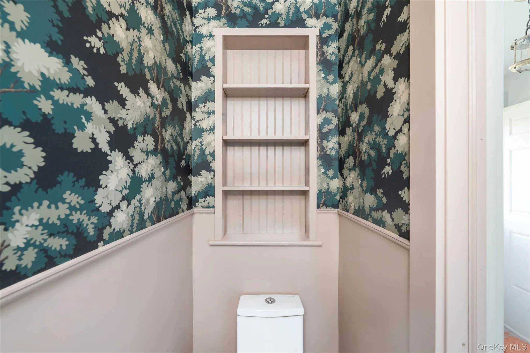 Powder room with custom built-in shelf, stunning wall paper and wainscoting Powder room with custom built-in shelf, stunning wall paper and wainscoting