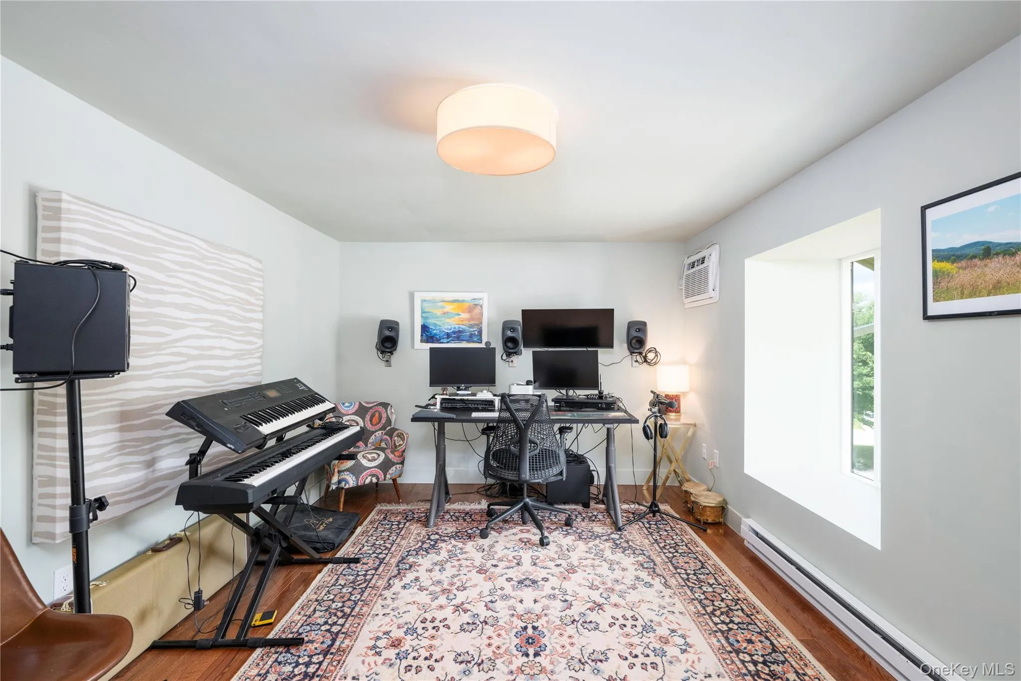 Versatile 3rd bed room featuring wood flooring, a contemporary drum light fixture, and light gray wall paint Versatile 3rd bed room featuring wood flooring, a contemporary drum light fixture, and light gray wall paint