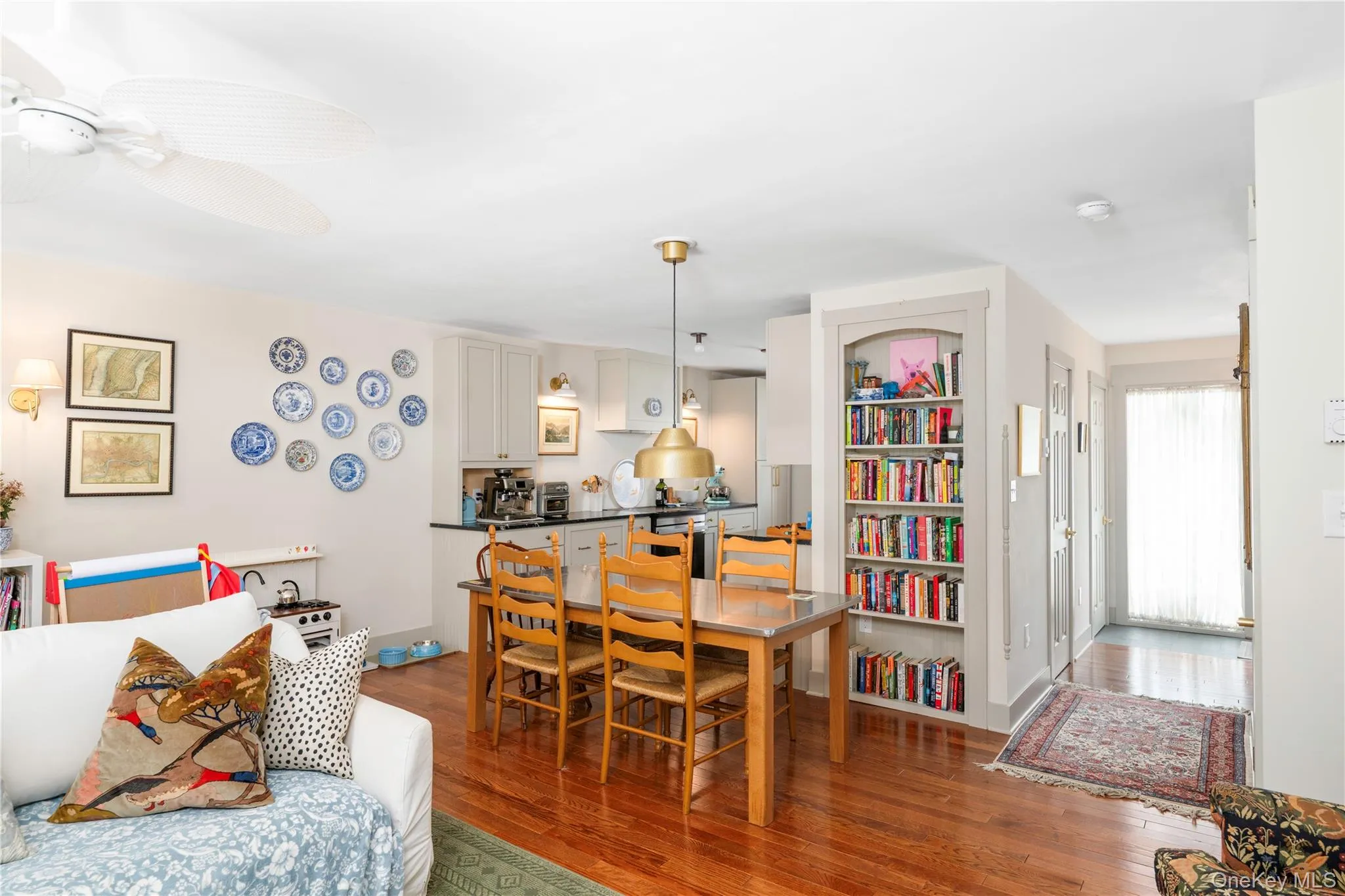 Dining Area with hardwood floors and a custom built-in floor to ceiling shelf Dining Area with hardwood floors and a custom built-in floor to ceiling shelf
