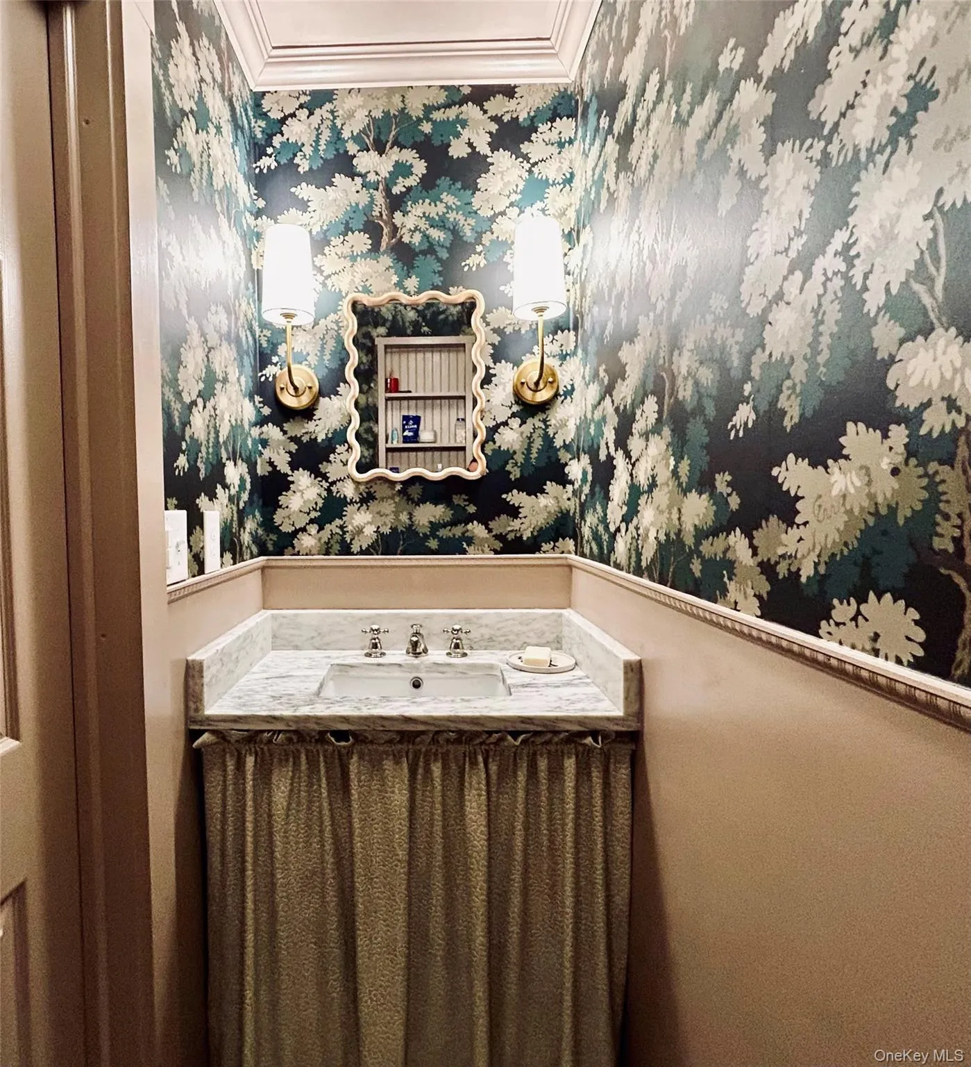 Powder room with marble vanity, custom wallpaper and light-colored wainscotting Powder room with marble vanity, custom wallpaper and light-colored wainscotting
