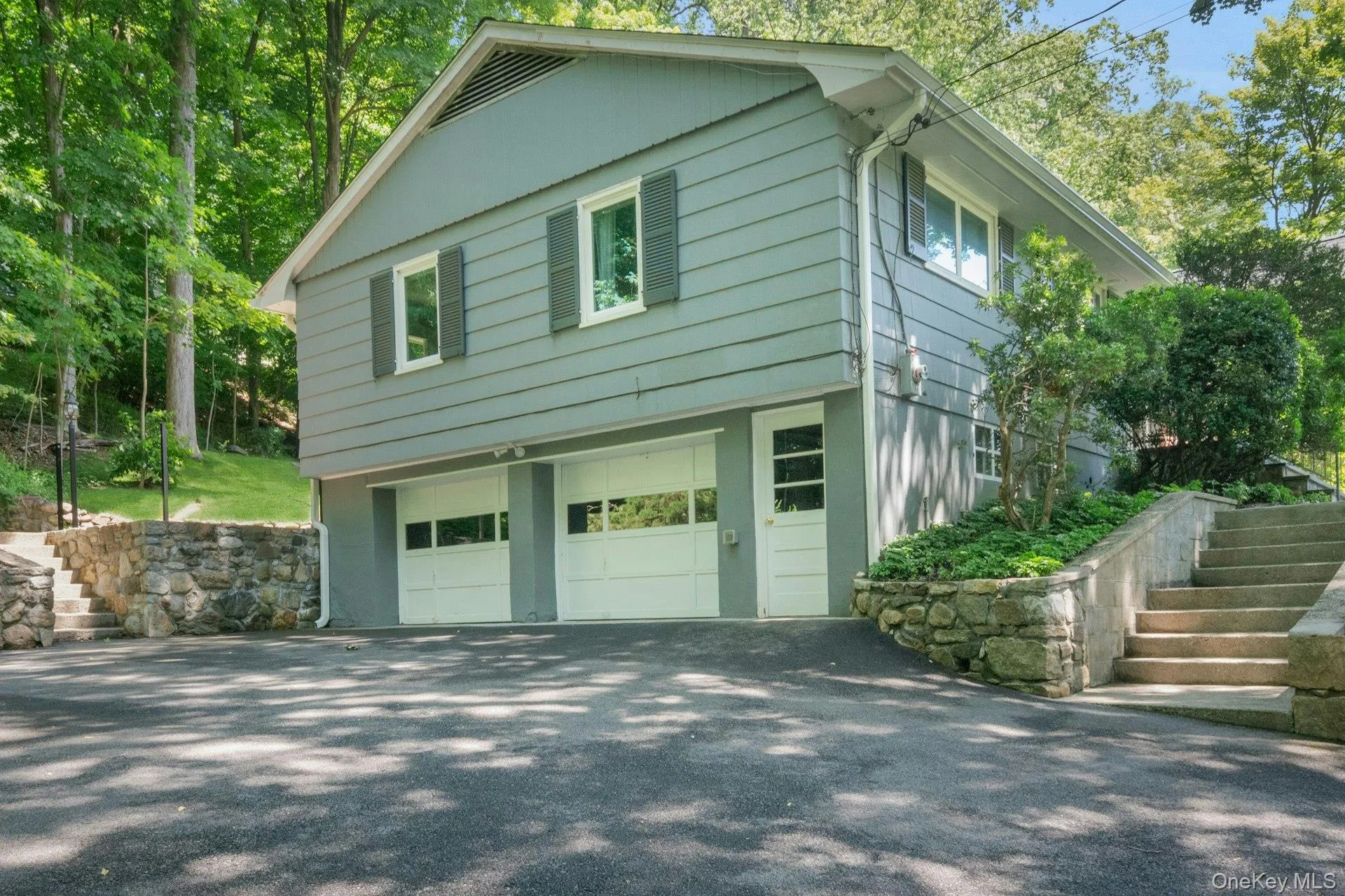 Ample parking for guests and entertaining. Side view of home over 2 car garage and door to lower level. Ample parking for guests and entertaining. Side view of home over 2 car garage and door to lower level.