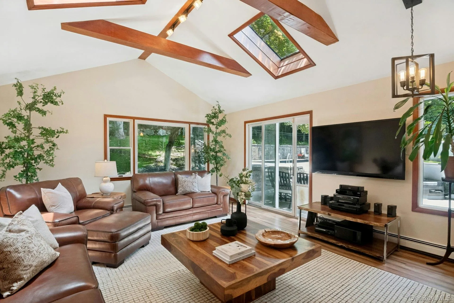 TV Room with stunning high wood beamed ceilings and dual skylights and SGD entry to deck. TV Room with stunning high wood beamed ceilings and dual skylights and SGD entry to deck.