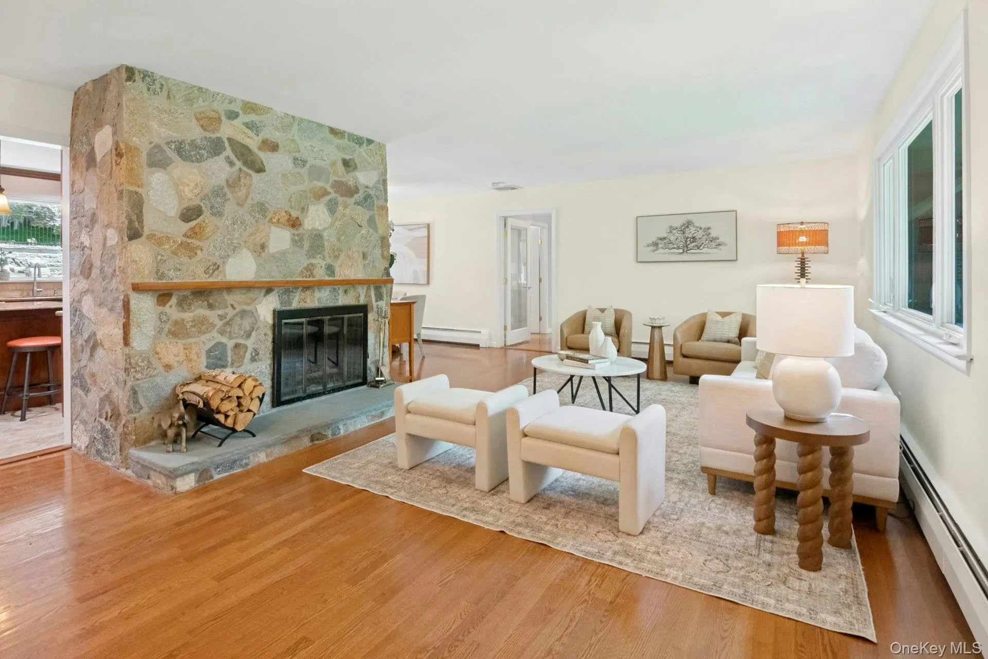 Enter into the bright open living room anchored by the beautiful stone fireplace. Enter into the bright open living room anchored by the beautiful stone fireplace.