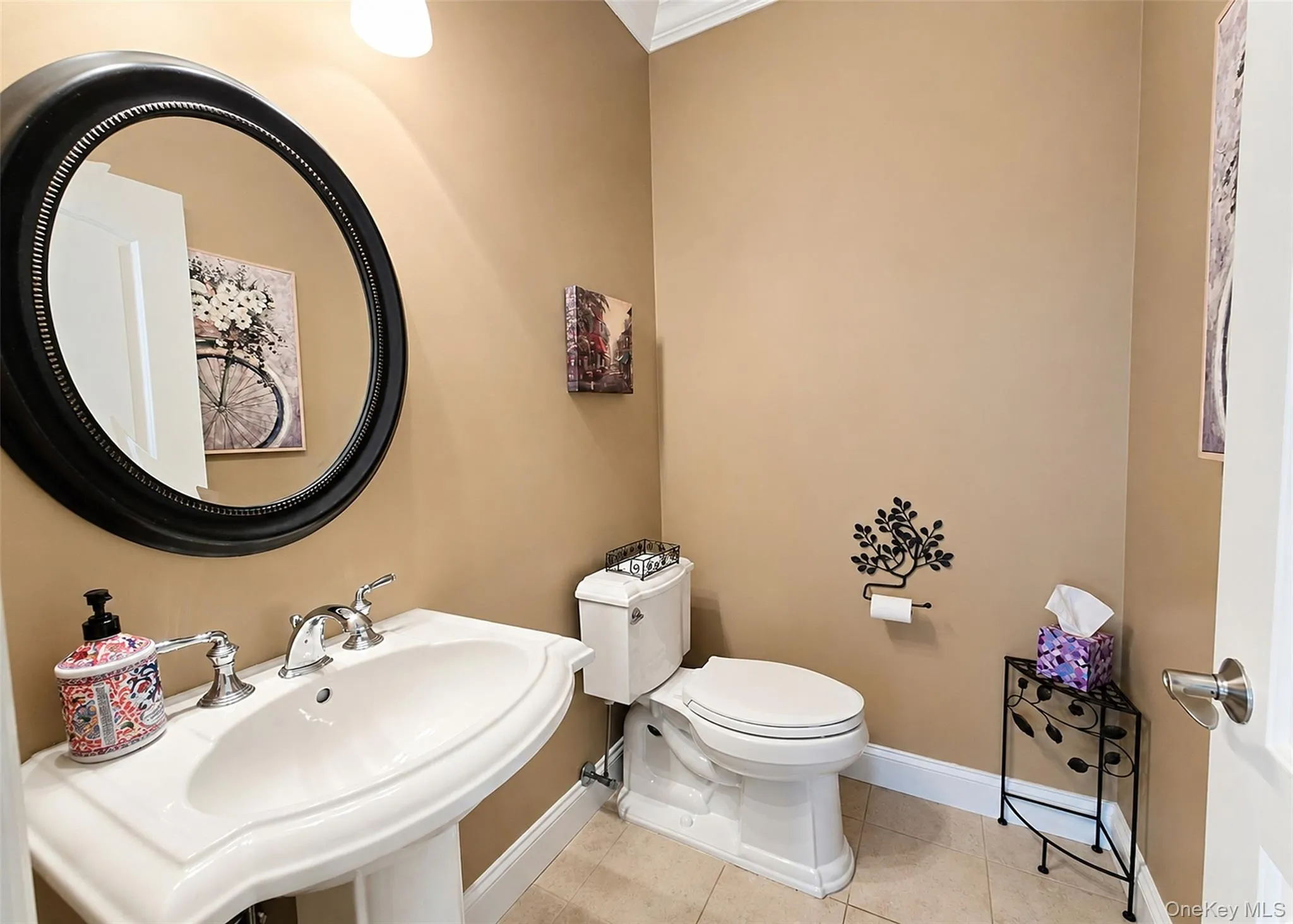 Half Bath With Kohler Pedestal Sink/Toilet, Neutral Ceramic Tile Flooring, & Pocket Door. Half Bath With Kohler Pedestal Sink/Toilet, Neutral Ceramic Tile Flooring, & Pocket Door.