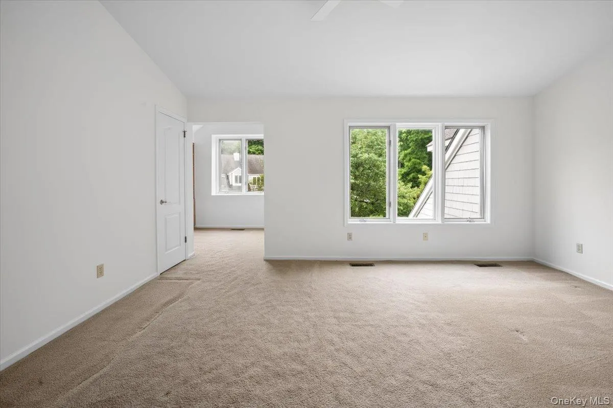 Sunny and inviting space with alcove and 2 walk in closet and access to primary bathroom Sunny and inviting space with alcove and 2 walk in closet and access to primary bathroom