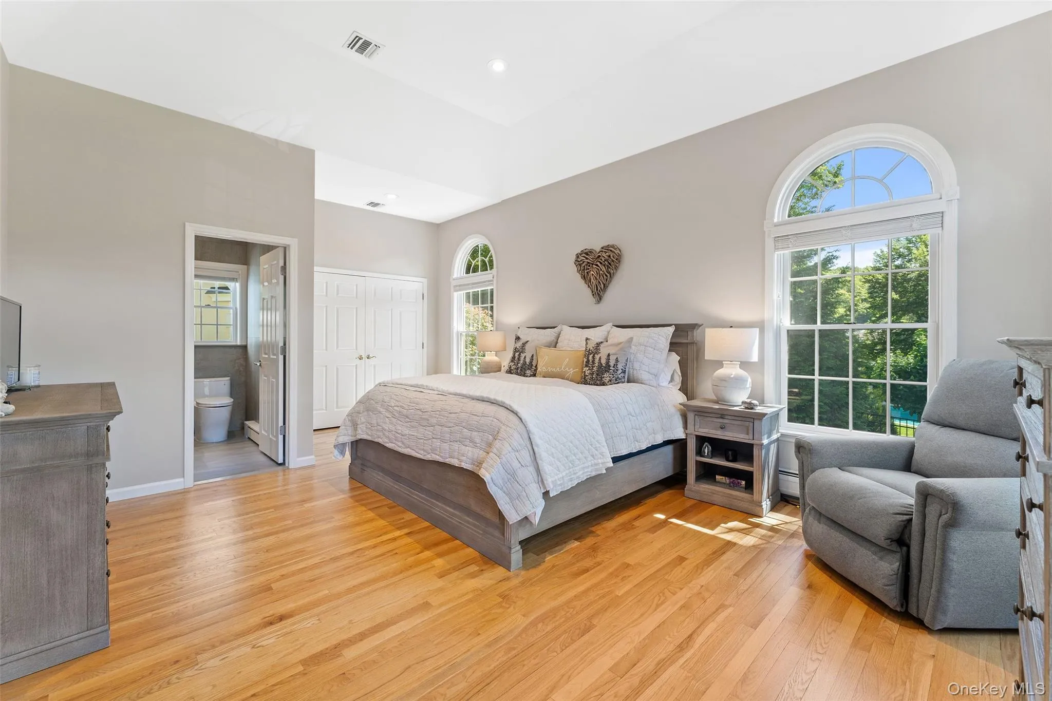 Bedroom featuring light wood-style flooring, ensuite bathroom, a closet, and recessed lighting Bedroom featuring light wood-style flooring, ensuite bathroom, a closet, and recessed lighting