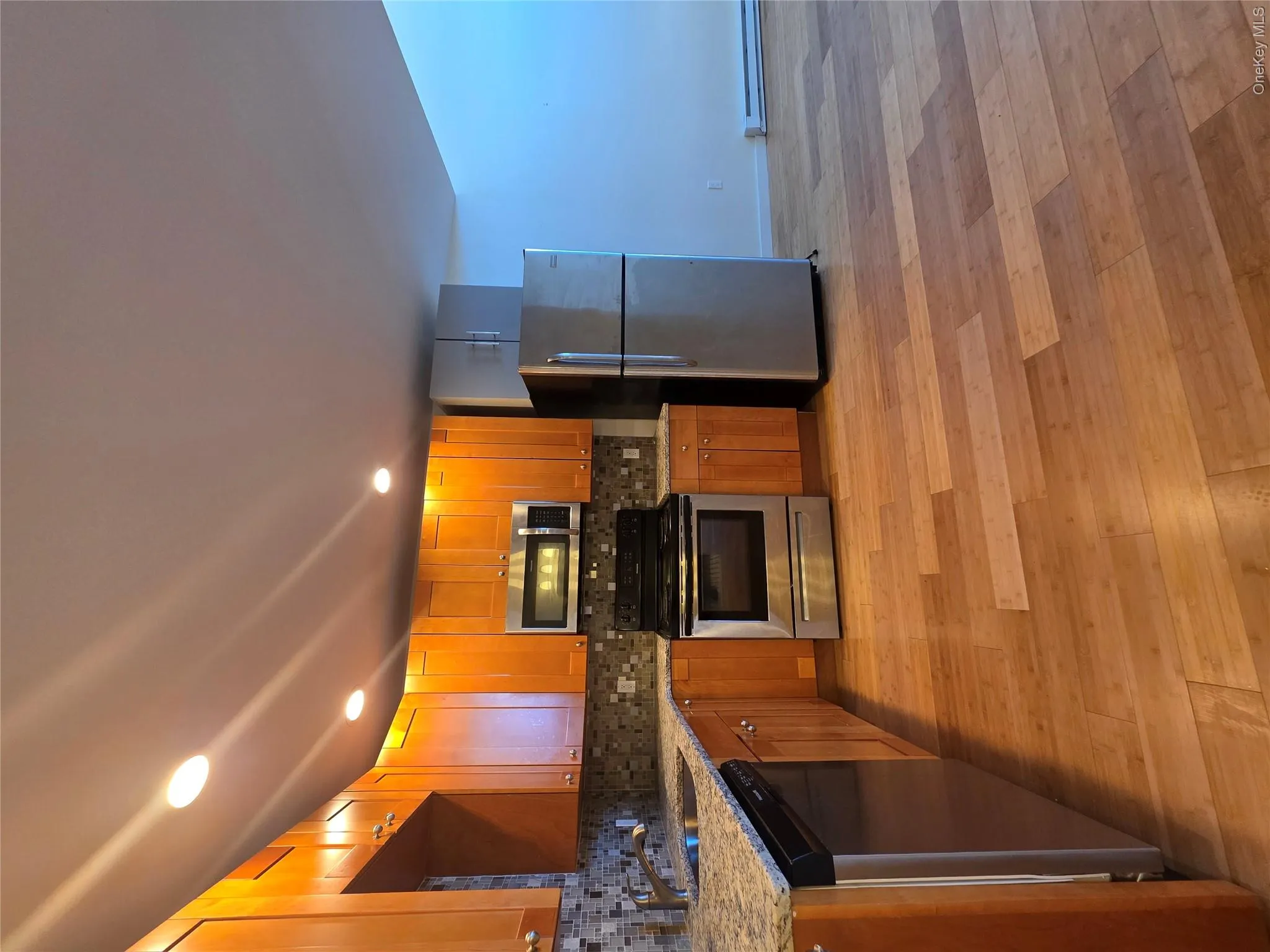 Kitchen featuring dishwashing machine, stove, a sink, fridge, and light stone countertops Kitchen featuring dishwashing machine, stove, a sink, fridge, and light stone countertops