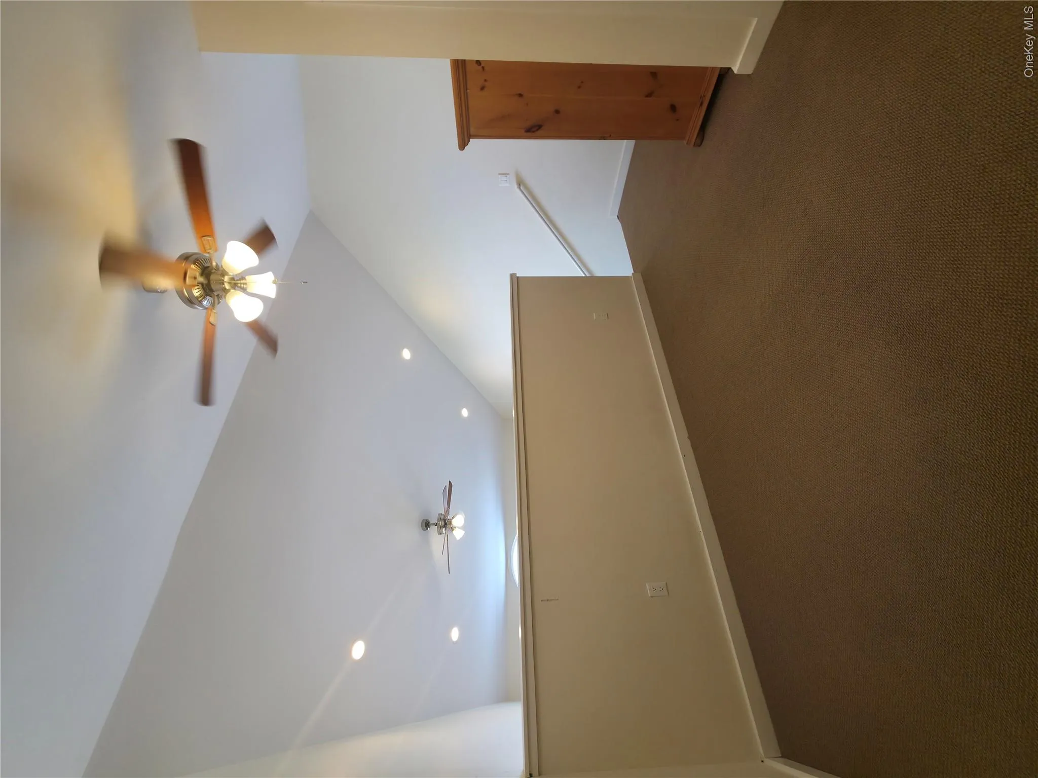 Bonus room with a ceiling fan, lofted ceiling, baseboards, and dark colored carpet Bonus room with a ceiling fan, lofted ceiling, baseboards, and dark colored carpet