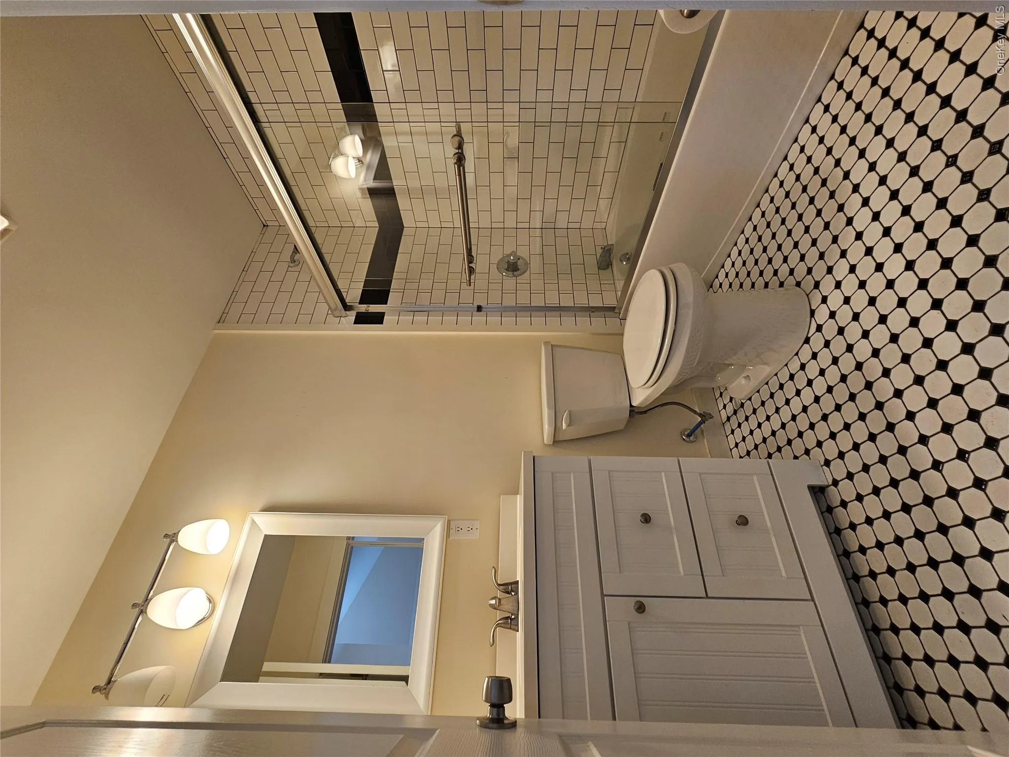Full bathroom with vanity, combined bath / shower with glass door, and toilet Full bathroom with vanity, combined bath / shower with glass door, and toilet