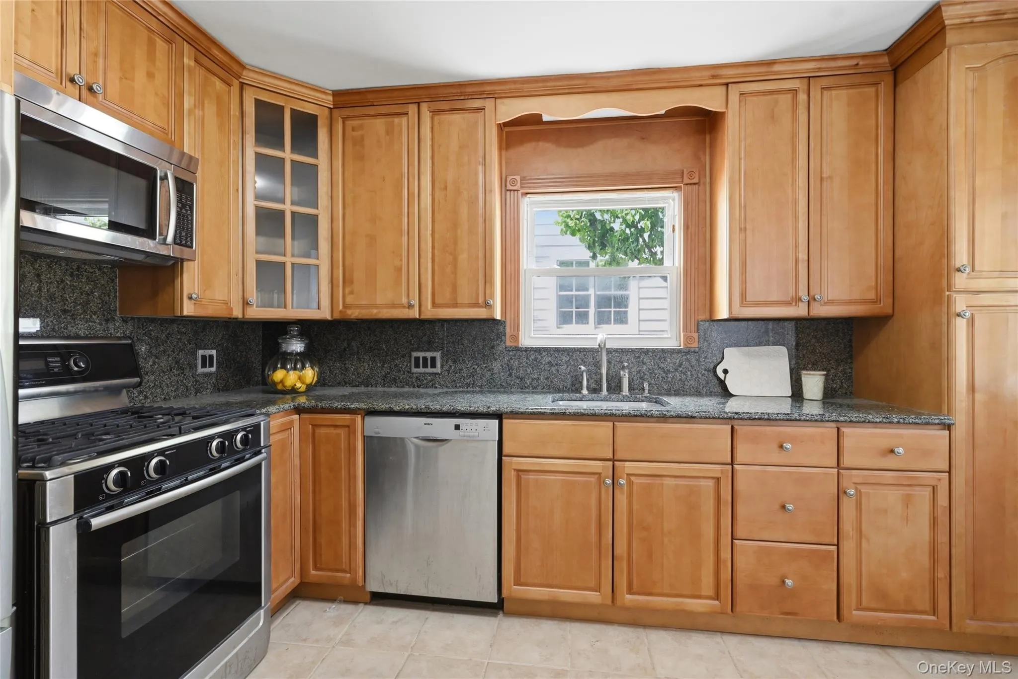 Updated kitchen with wood cabinetry & granite counters. Updated kitchen with wood cabinetry & granite counters.
