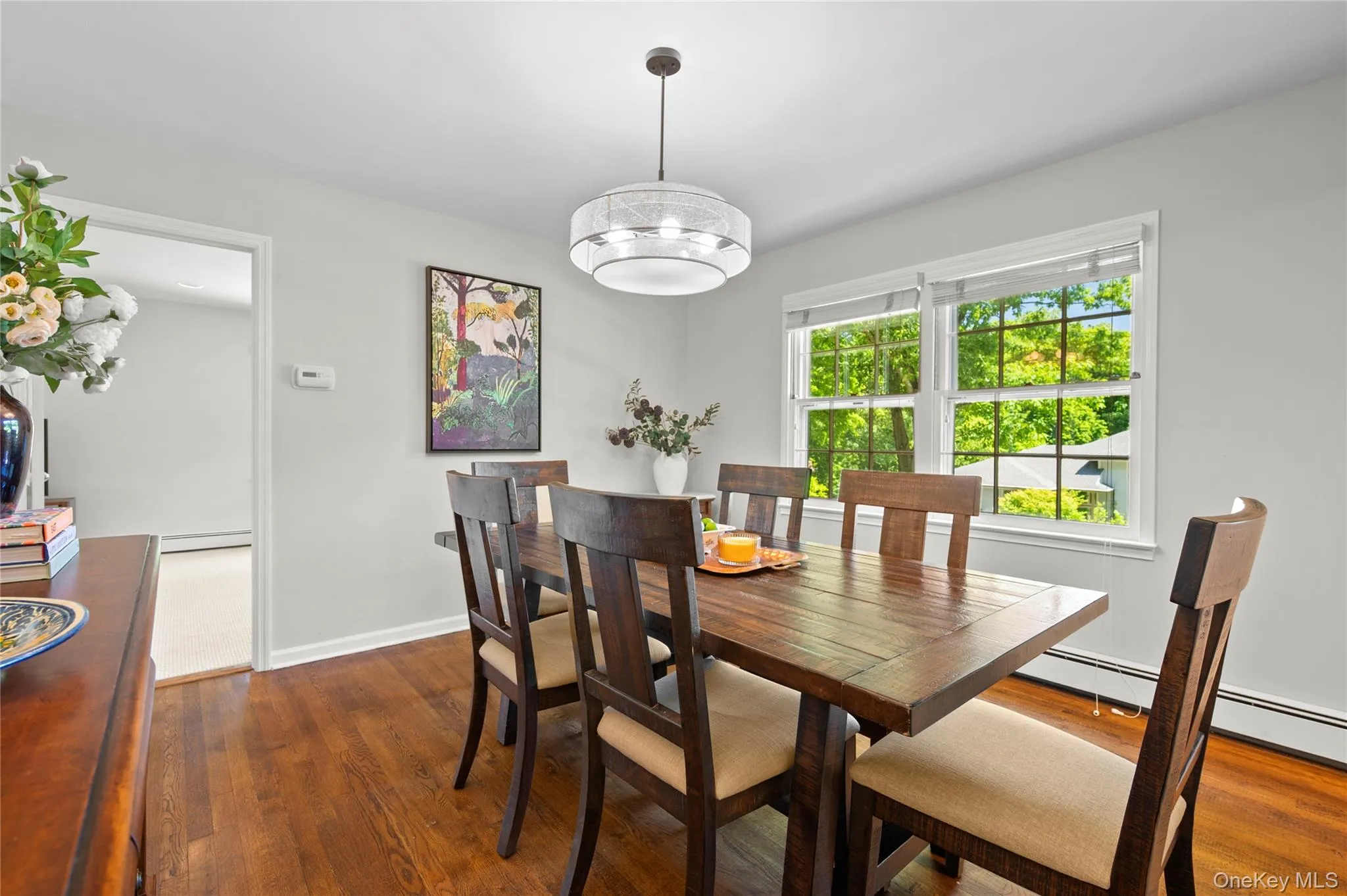 Dining room with large windows and a beautiful contemporary light fixture Dining room with large windows and a beautiful contemporary light fixture