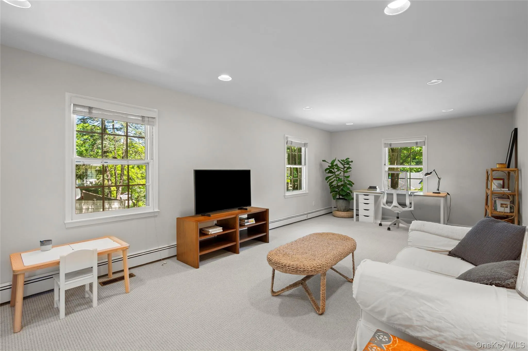 Spacious family room, recessed lighting, and light-toned carpet flooring Spacious family room, recessed lighting, and light-toned carpet flooring