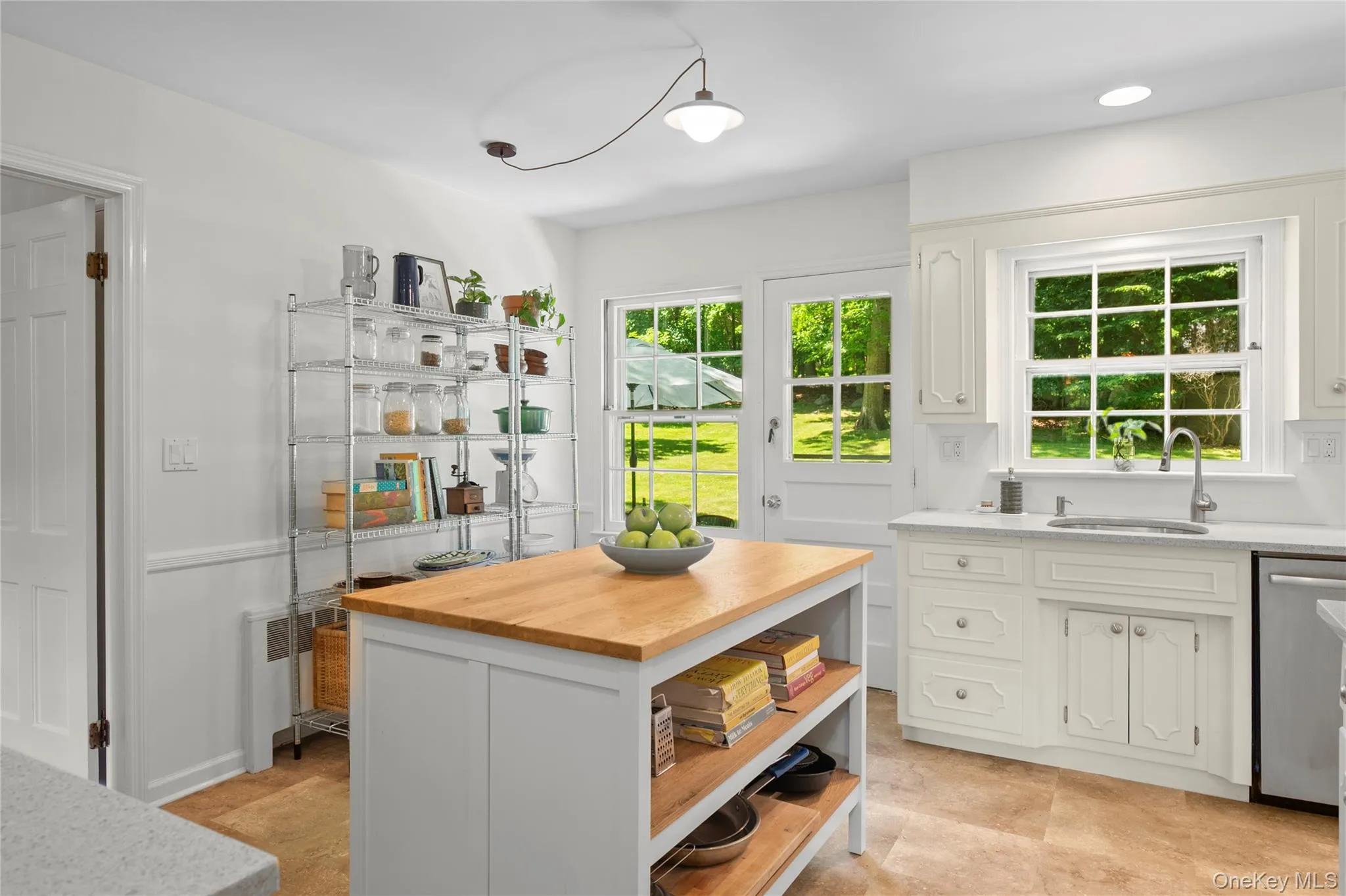 Sun-filled kitchen with durable tile floors and multiple windows creating a bright, welcoming atmosphere. Sun-filled kitchen with durable tile floors and multiple windows creating a bright, welcoming atmosphere.