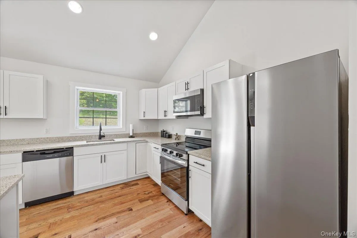 Kitchen features quartz counters and stainless steel appliances. Kitchen features quartz counters and stainless steel appliances.