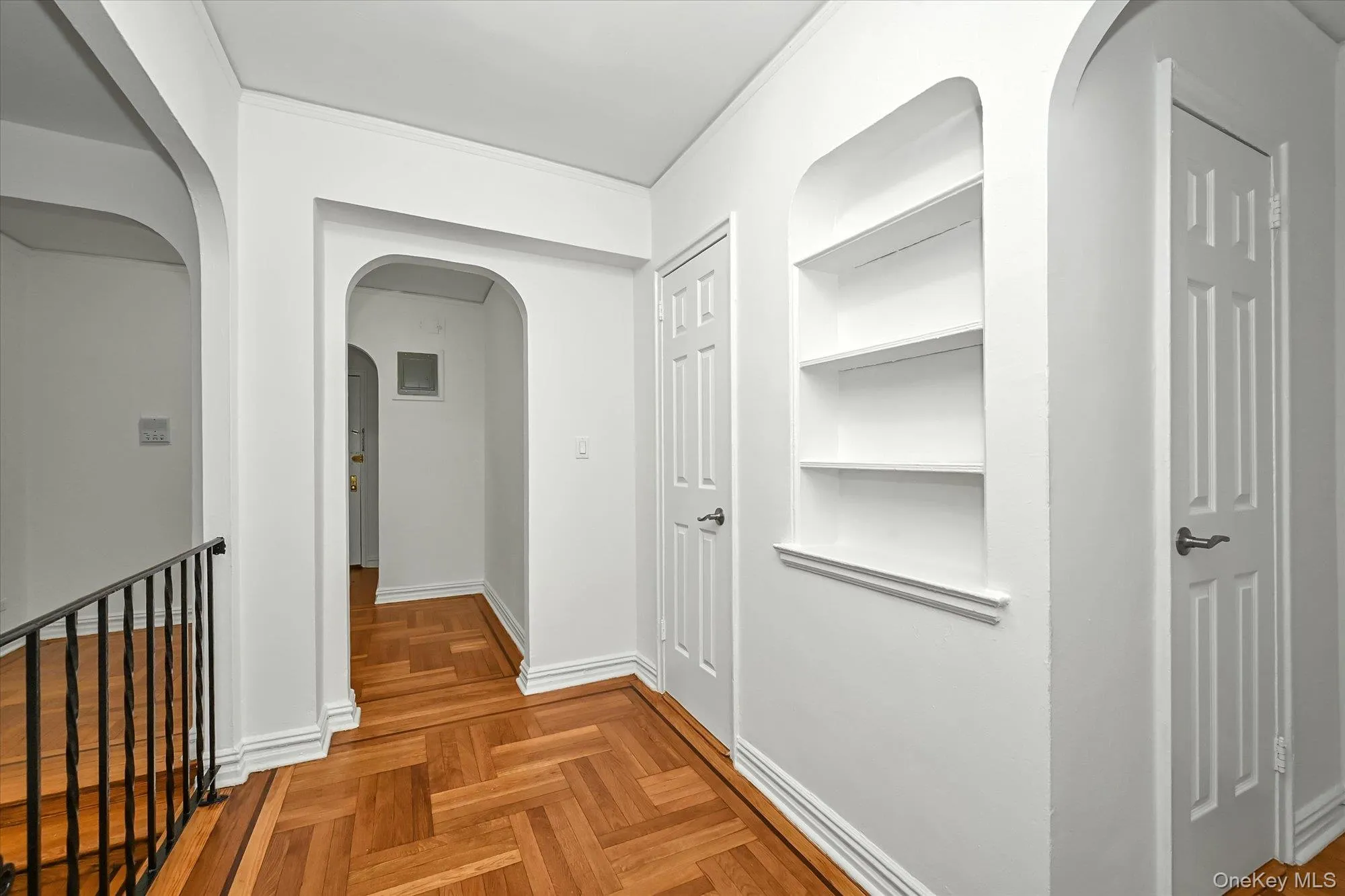 White walls accenting a herringbone wood-finish floor. White walls accenting a herringbone wood-finish floor.