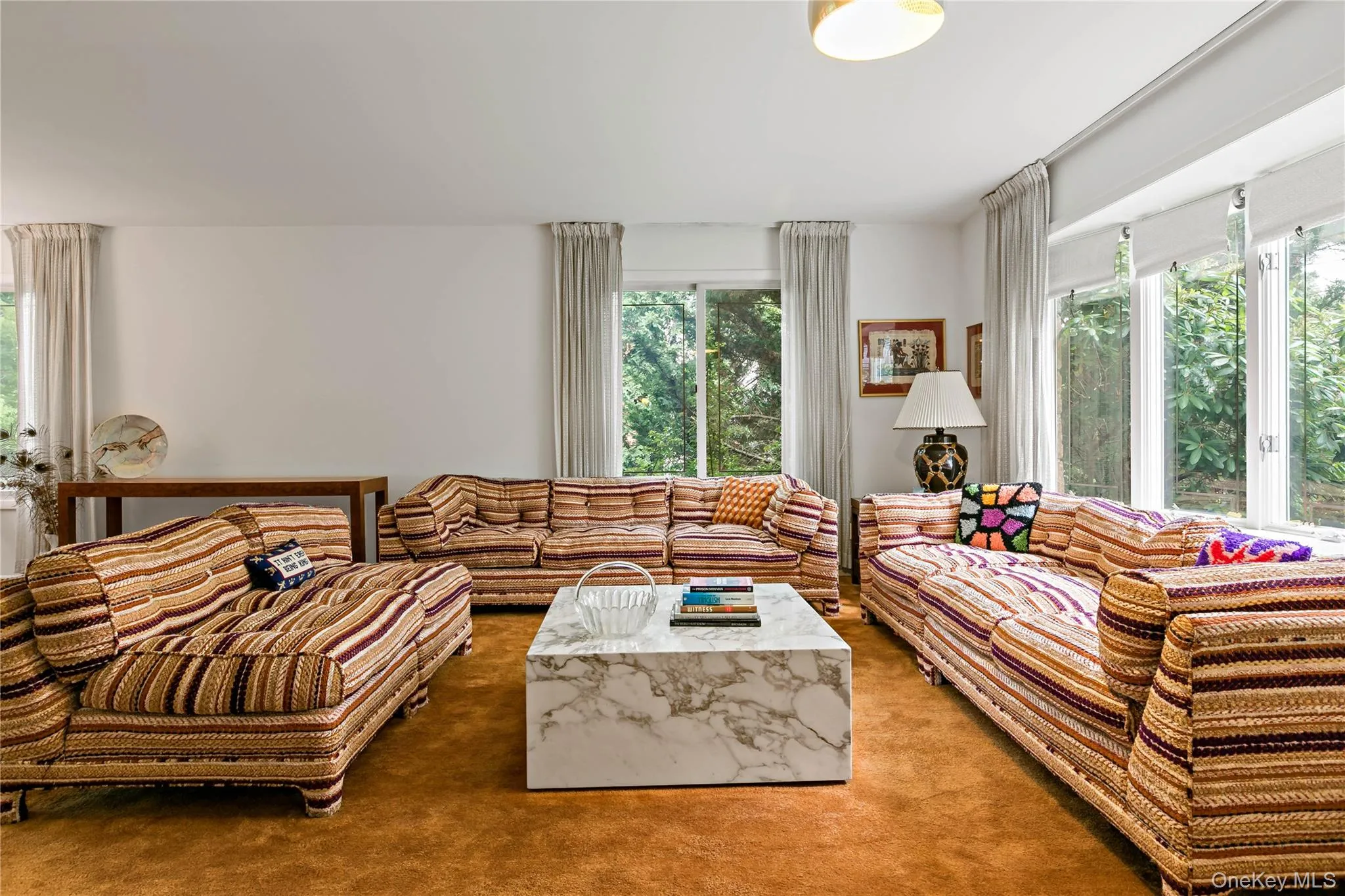 Seating area in the living room with walls of windows Seating area in the living room with walls of windows