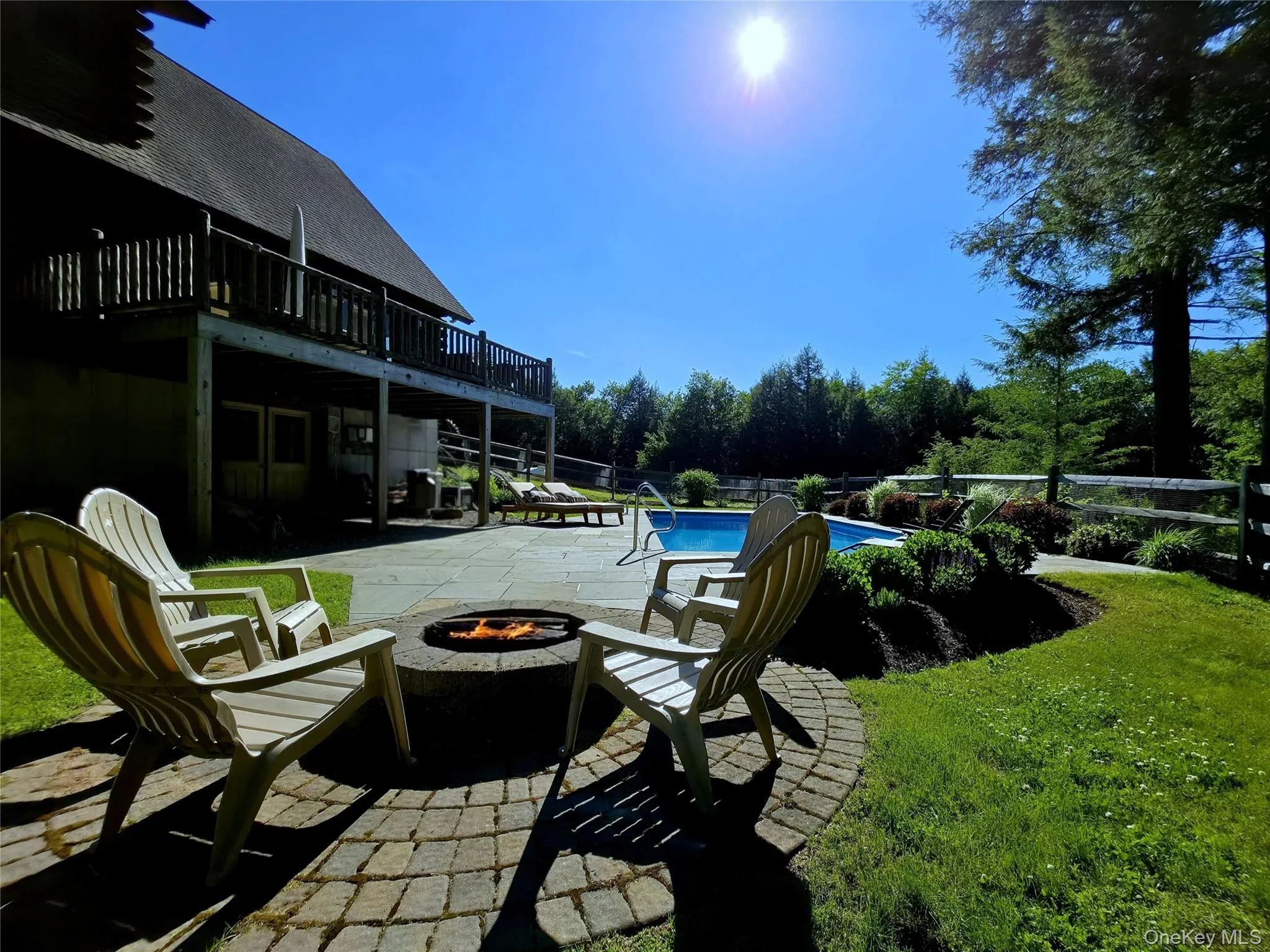 Fire pit area overlooking saltwater pool Fire pit area overlooking saltwater pool