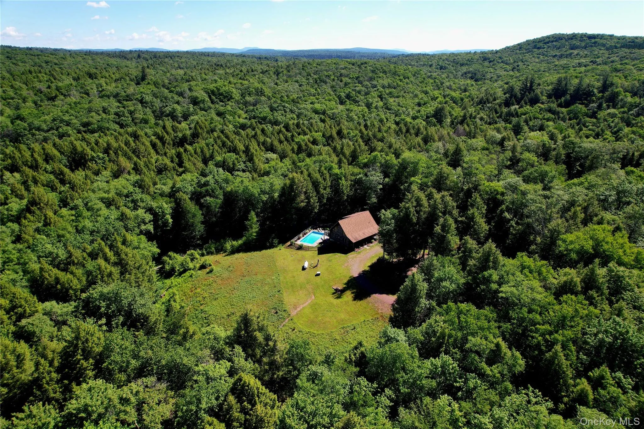 Aerial view of the cabin nestled in the woods Aerial view of the cabin nestled in the woods