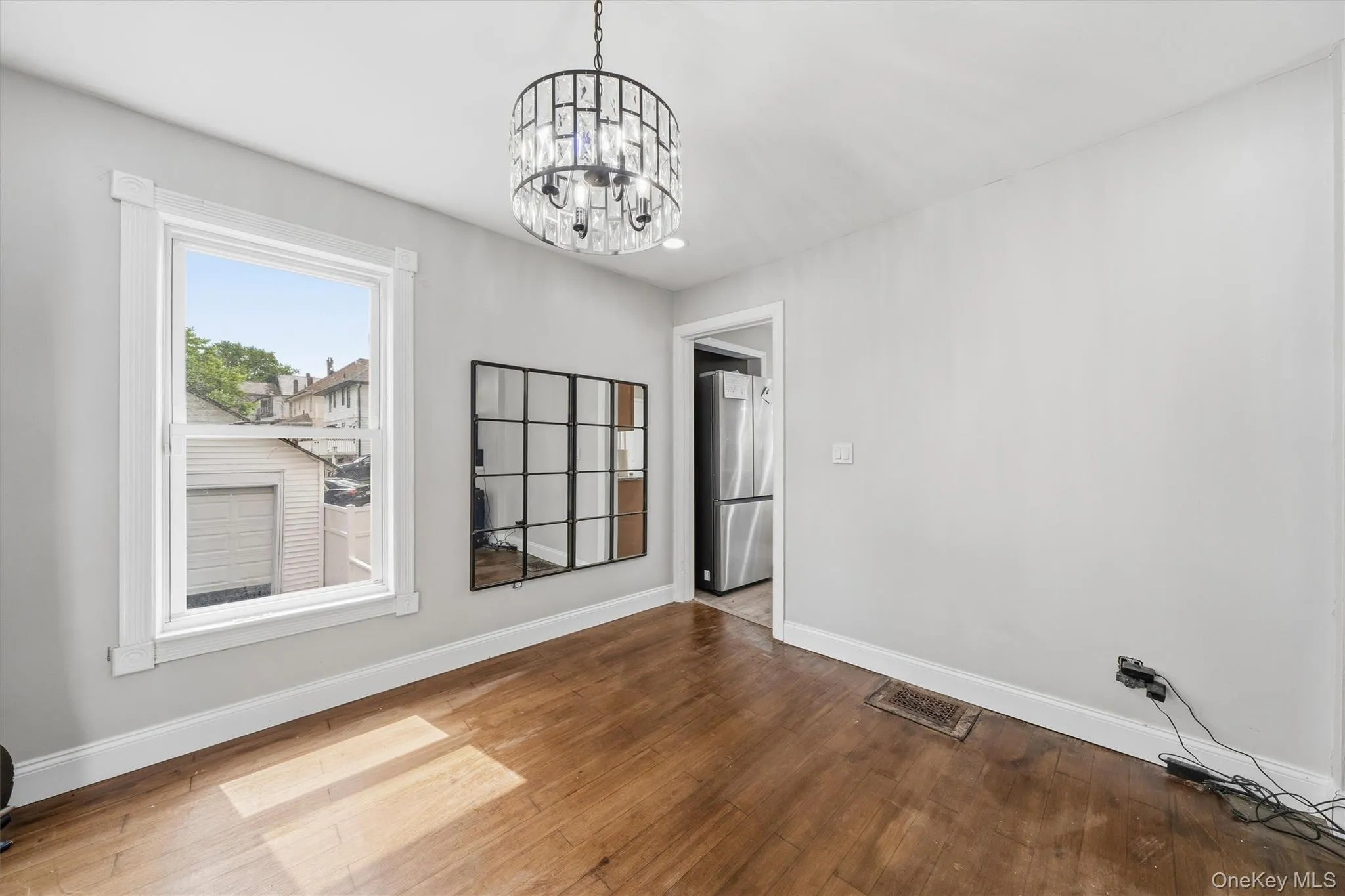Complemented with a crystal chandelier and hardwood flooring. Complemented with a crystal chandelier and hardwood flooring.