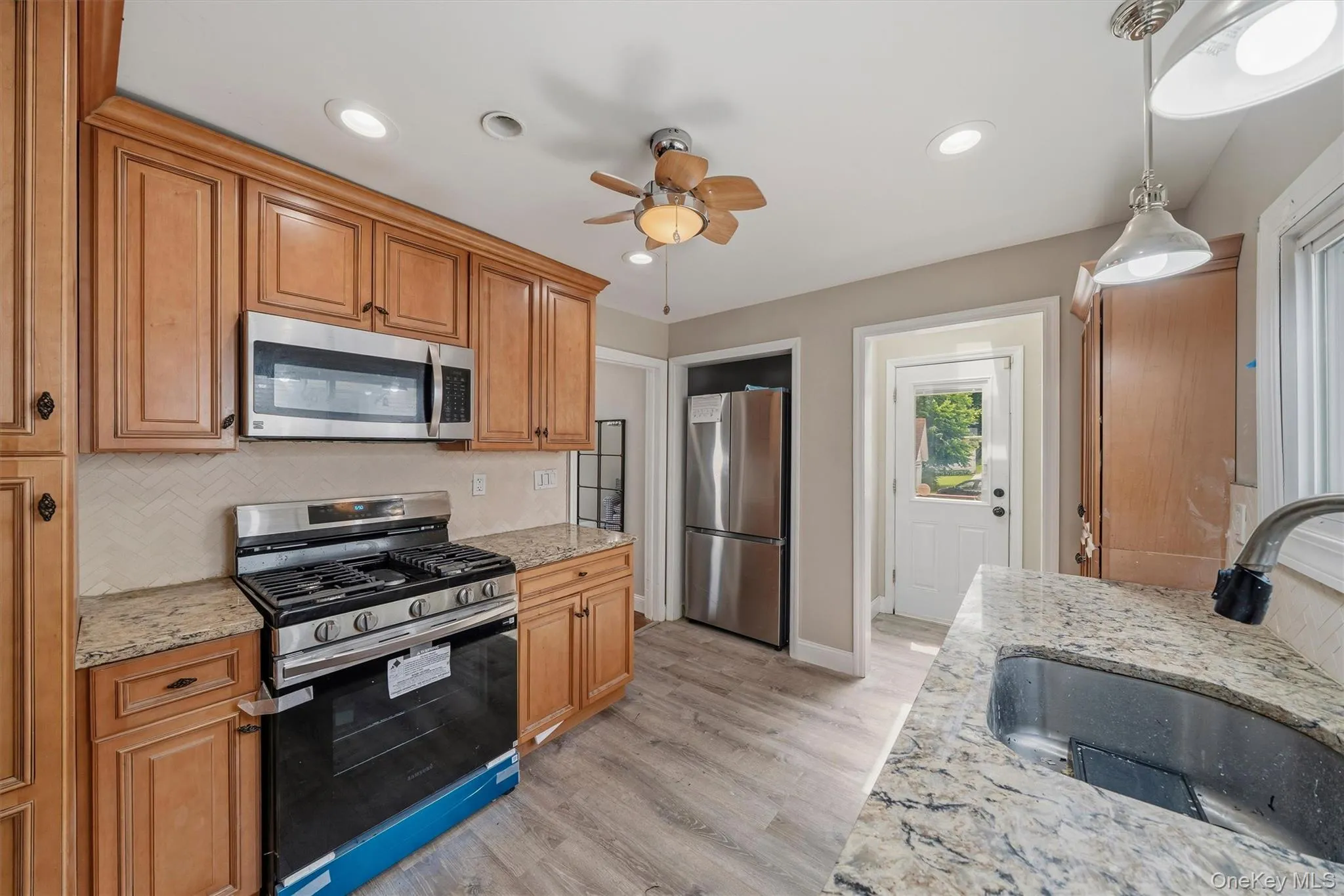 Updated Galley kitchen with new stove and new refrigerator. Updated Galley kitchen with new stove and new refrigerator.