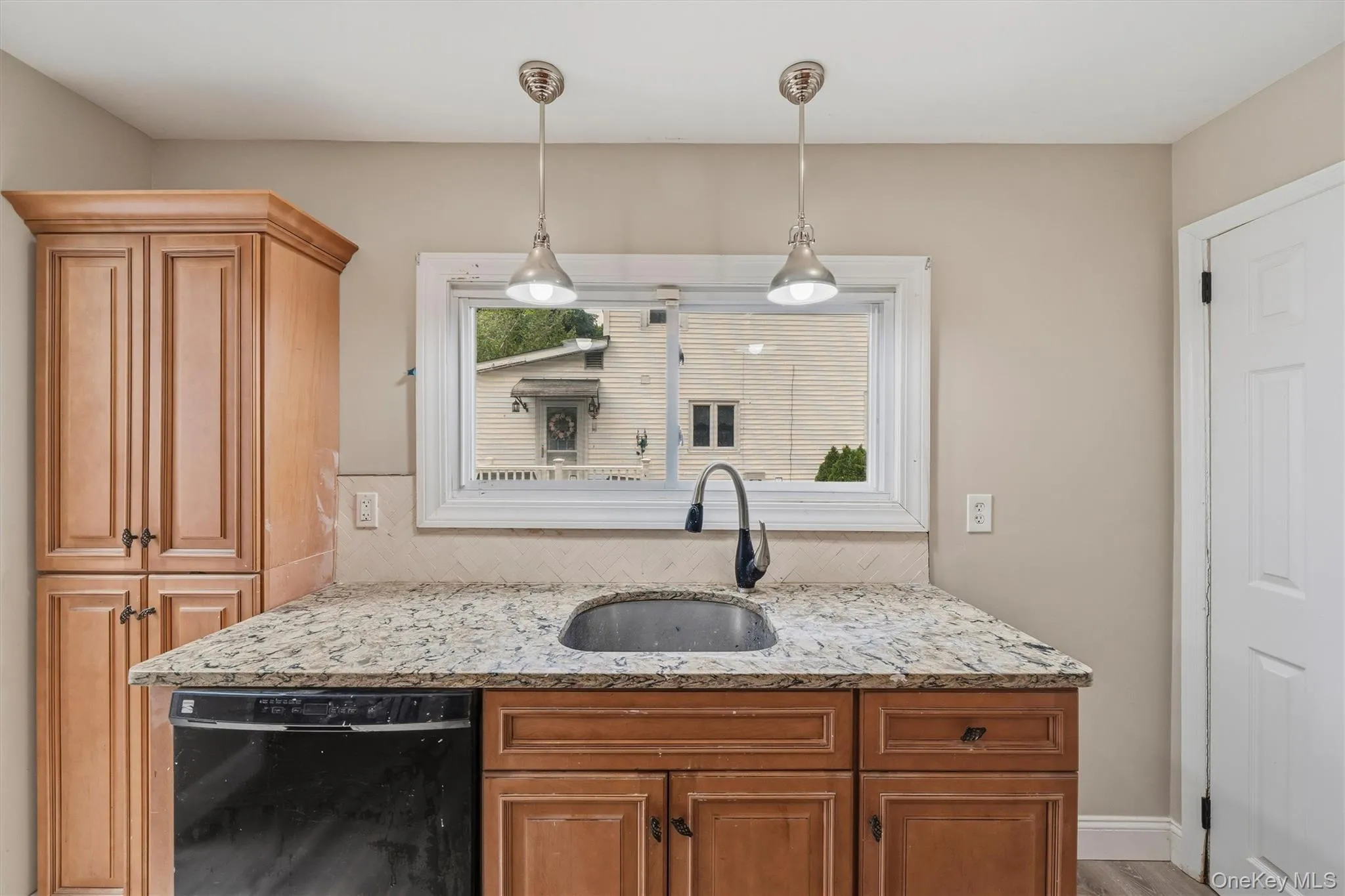 Granite counter top kitchen, with pendant lighting and pantry closet. Granite counter top kitchen, with pendant lighting and pantry closet.