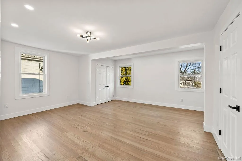 Unfurnished room with light wood-style flooring and baseboards Unfurnished room with light wood-style flooring and baseboards