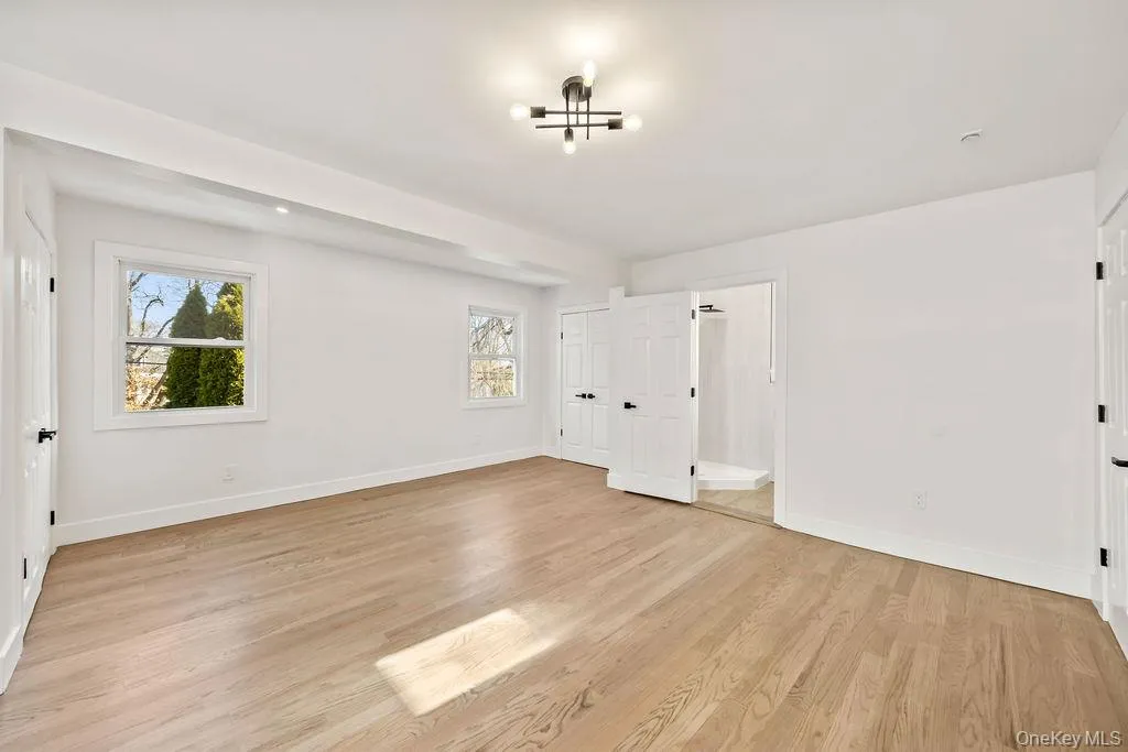 Unfurnished bedroom featuring light wood-style floors and baseboards Unfurnished bedroom featuring light wood-style floors and baseboards