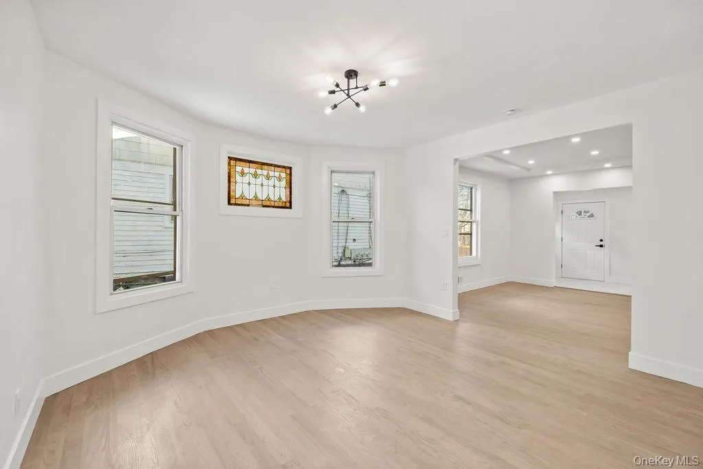 Spare room with light wood-style floors, recessed lighting, and a chandelier Spare room with light wood-style floors, recessed lighting, and a chandelier