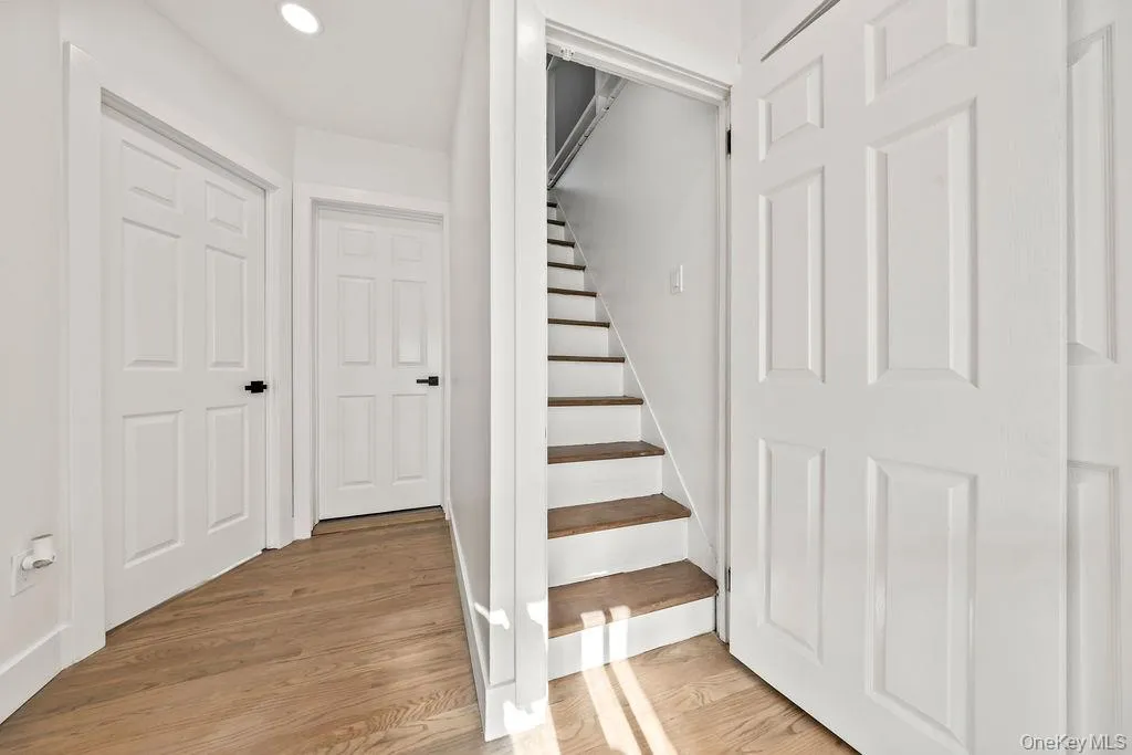 Stairway featuring wood finished floors and recessed lighting Stairway featuring wood finished floors and recessed lighting