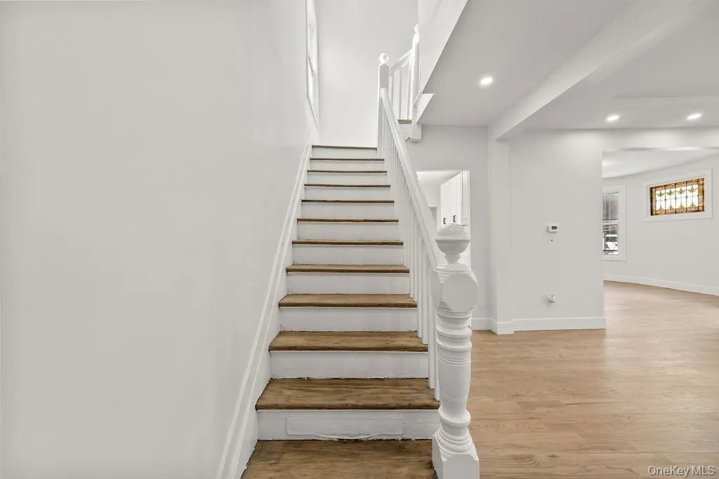 Stairs with wood finished floors and recessed lighting Stairs with wood finished floors and recessed lighting