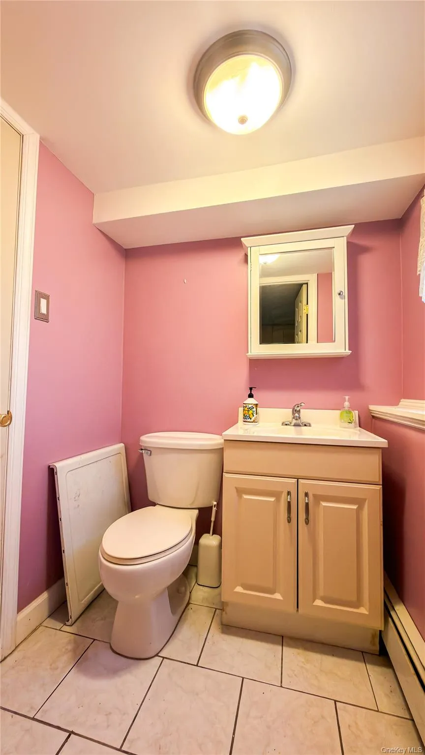 Lower level half bathroom with vanity and tile floors Lower level half bathroom with vanity and tile floors
