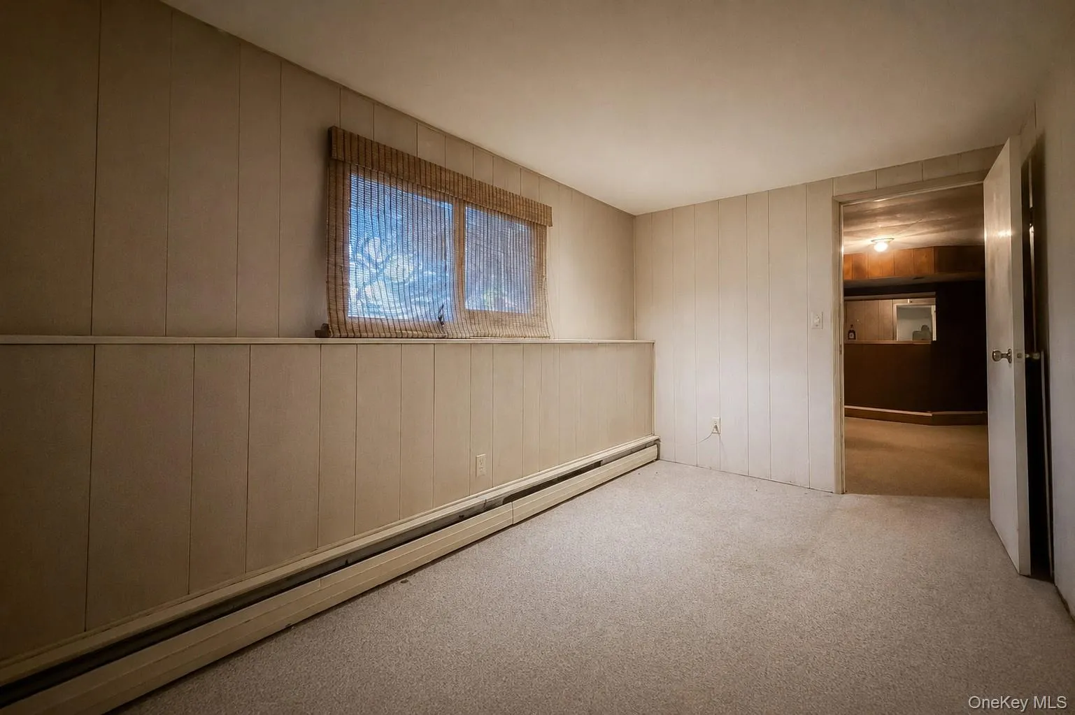 Lower level den / multi-purpose room with door to garage or half bathroom Lower level den / multi-purpose room with door to garage or half bathroom