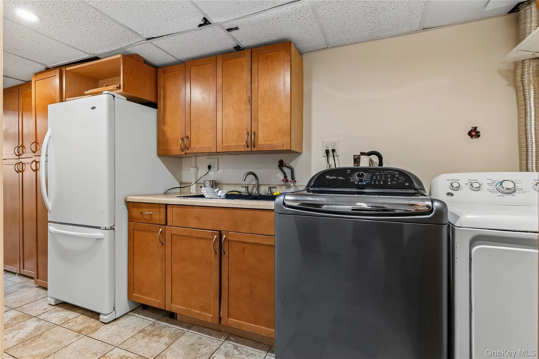Additional refrigerator and ample laundry room completes the lower level. Additional refrigerator and ample laundry room completes the lower level.