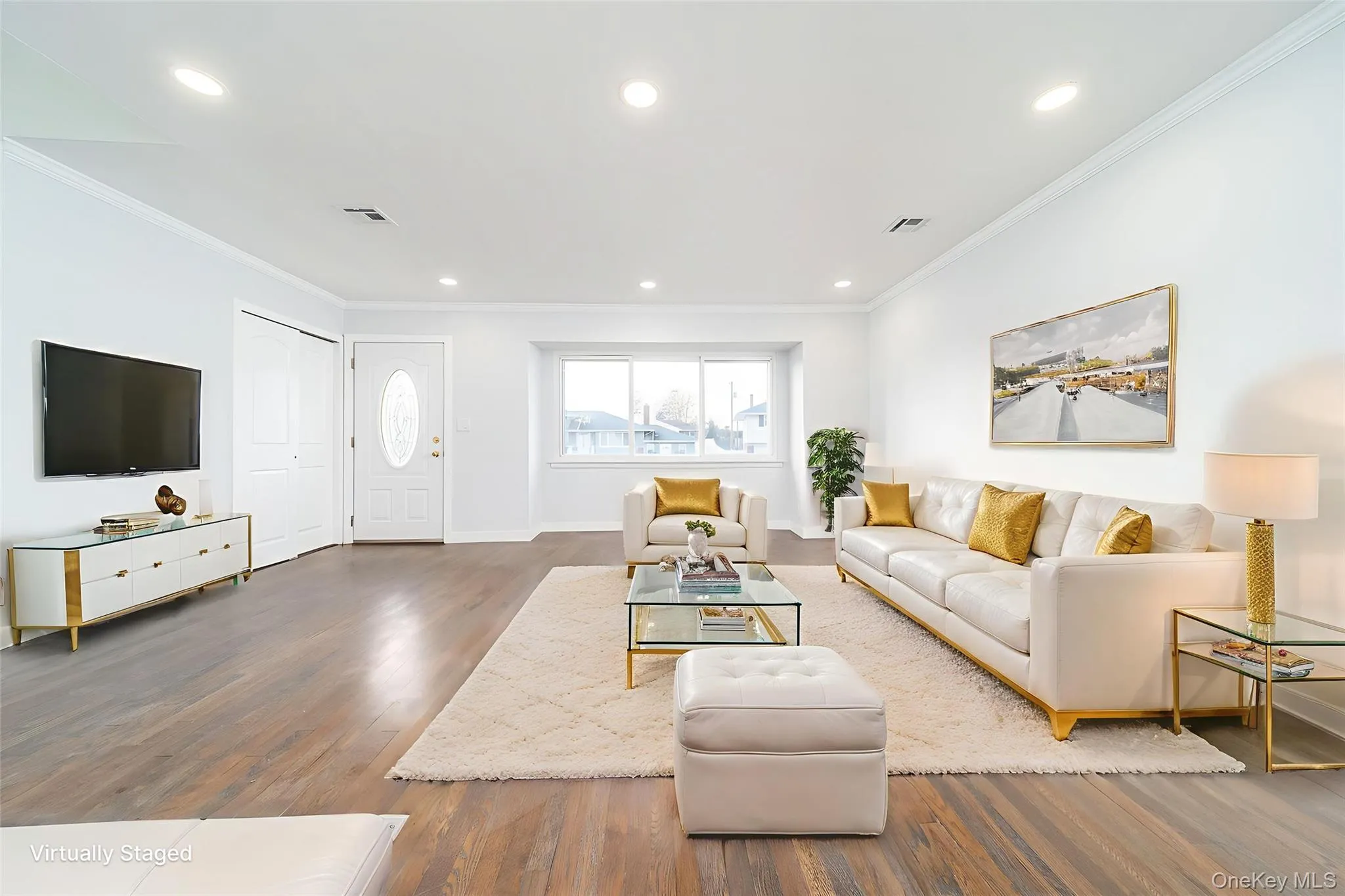 Living area with recessed lighting, wood finished floors, and ornamental molding Living area with recessed lighting, wood finished floors, and ornamental molding