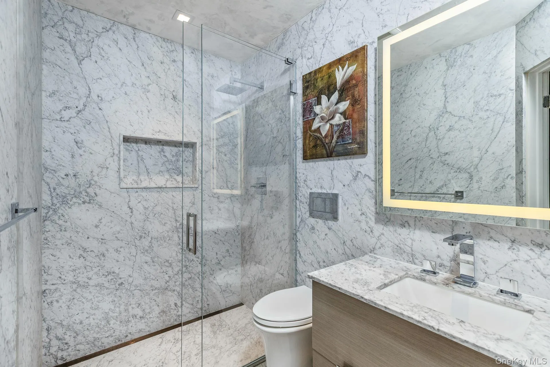 Full bathroom with tile walls, a marble finish shower, and vanity Full bathroom with tile walls, a marble finish shower, and vanity