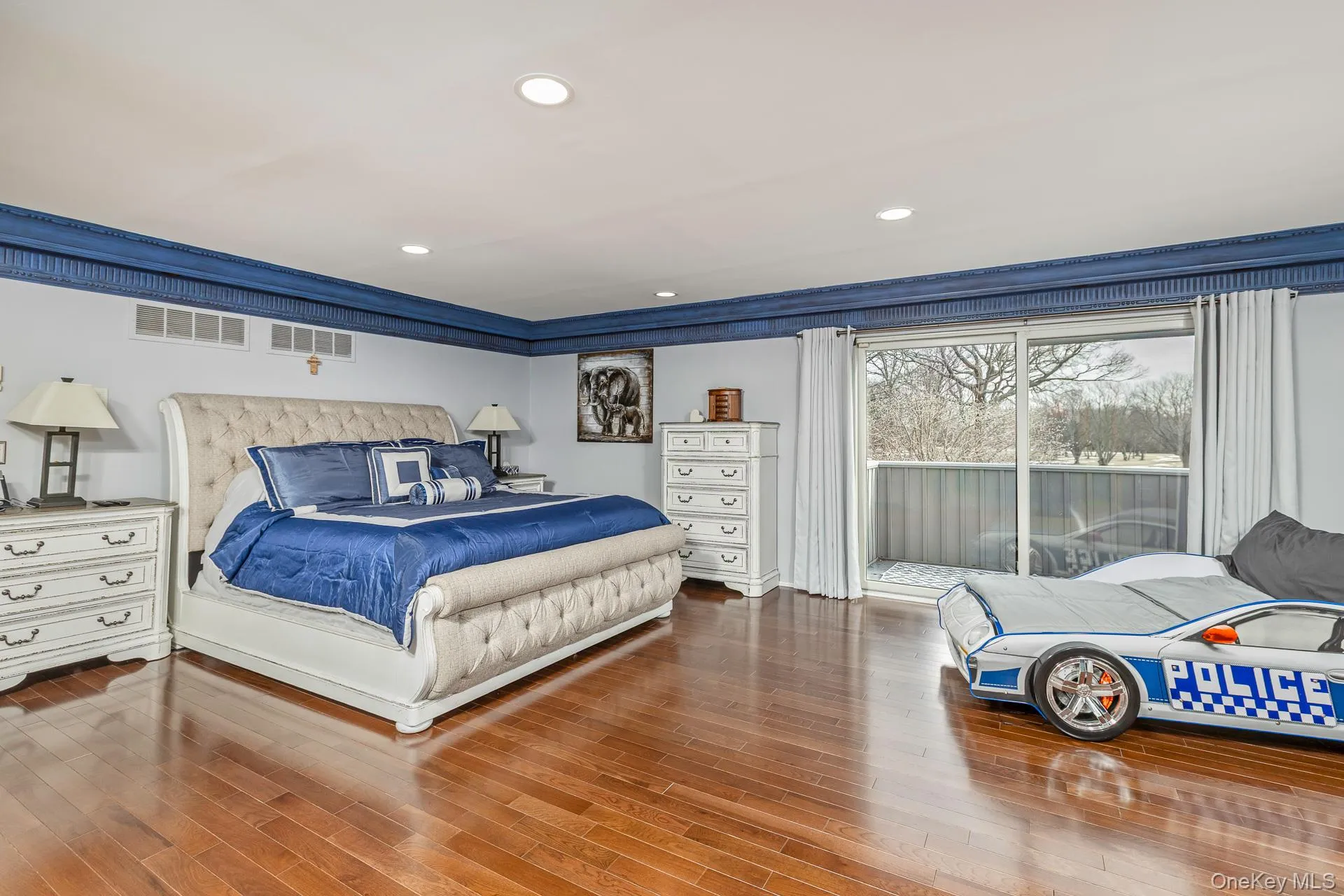 Bedroom featuring recessed lighting, wood finished floors, and access to exterior Bedroom featuring recessed lighting, wood finished floors, and access to exterior