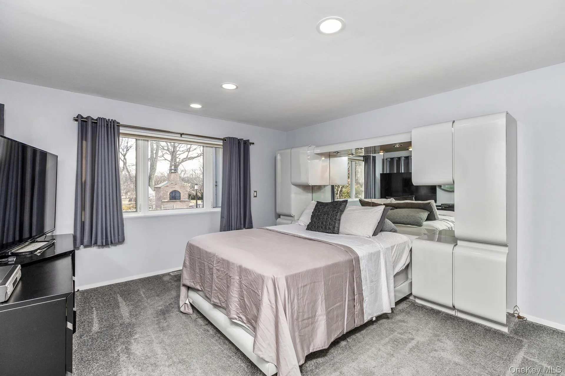 Bedroom with carpet, multiple windows, and recessed lighting Bedroom with carpet, multiple windows, and recessed lighting