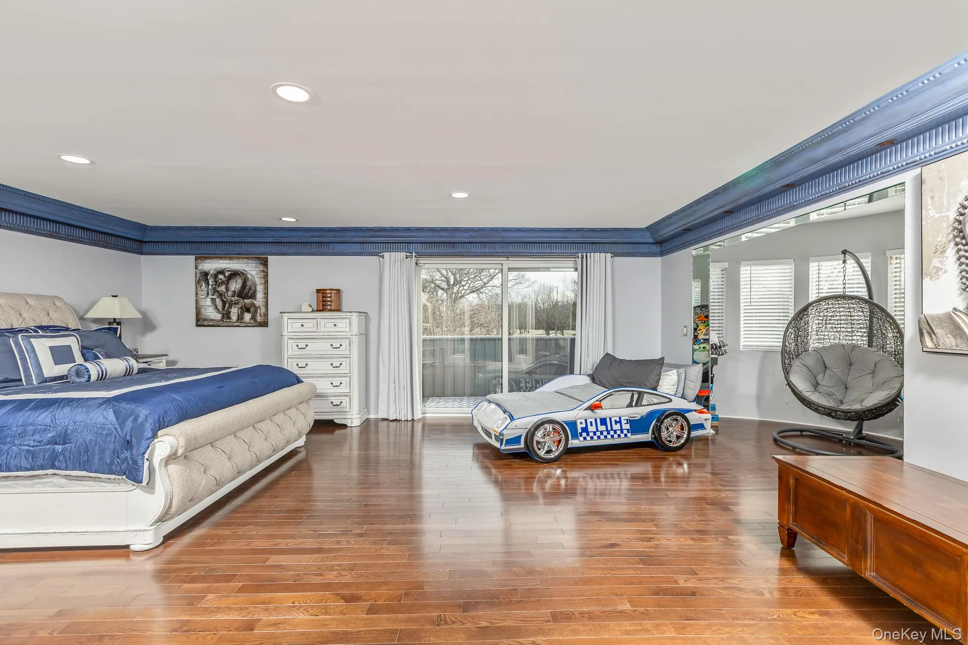 Bedroom featuring light wood finished floors, crown molding, and recessed lighting Bedroom featuring light wood finished floors, crown molding, and recessed lighting