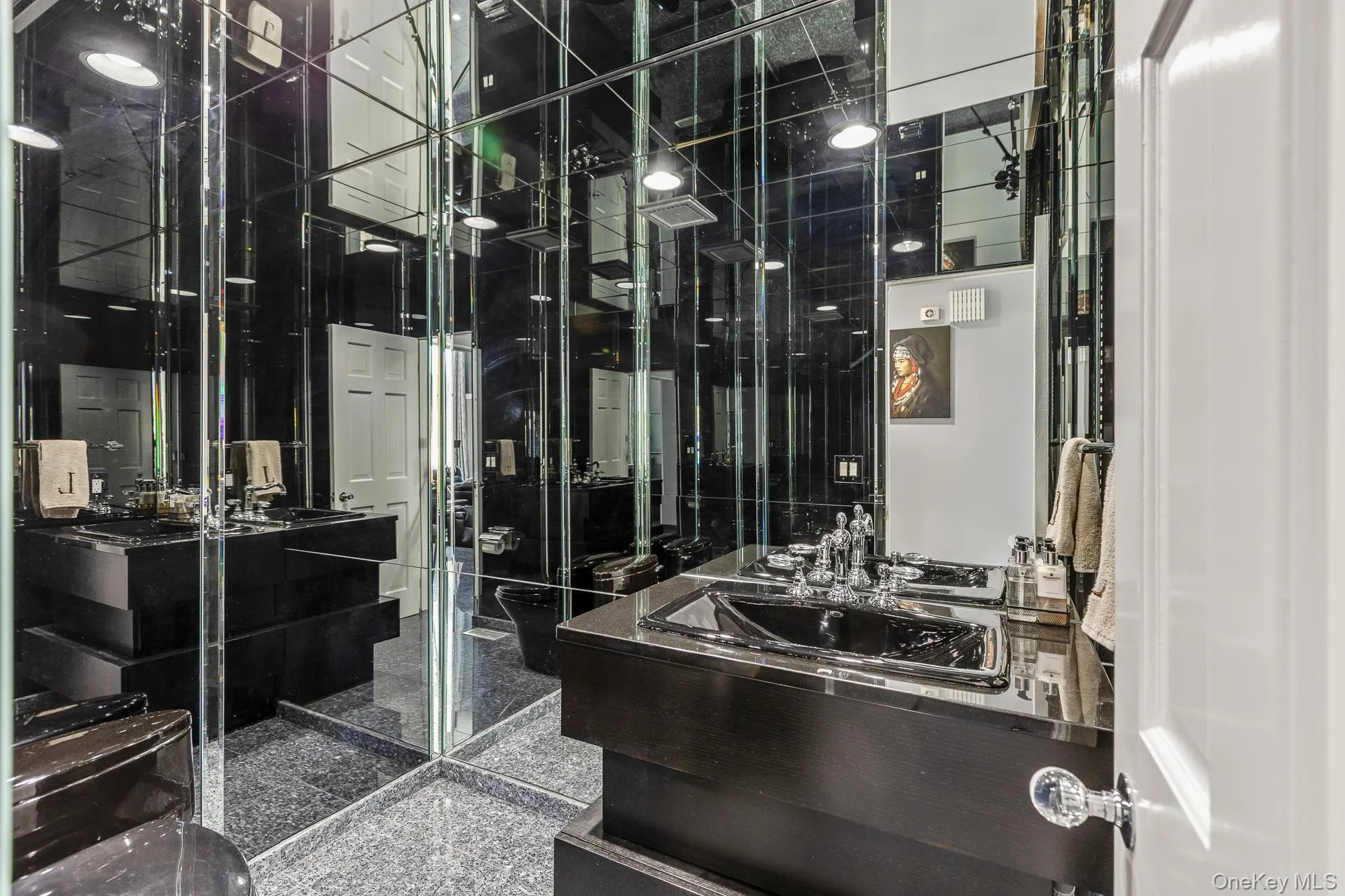 Bathroom featuring granite tiled floors and vanity Bathroom featuring granite tiled floors and vanity