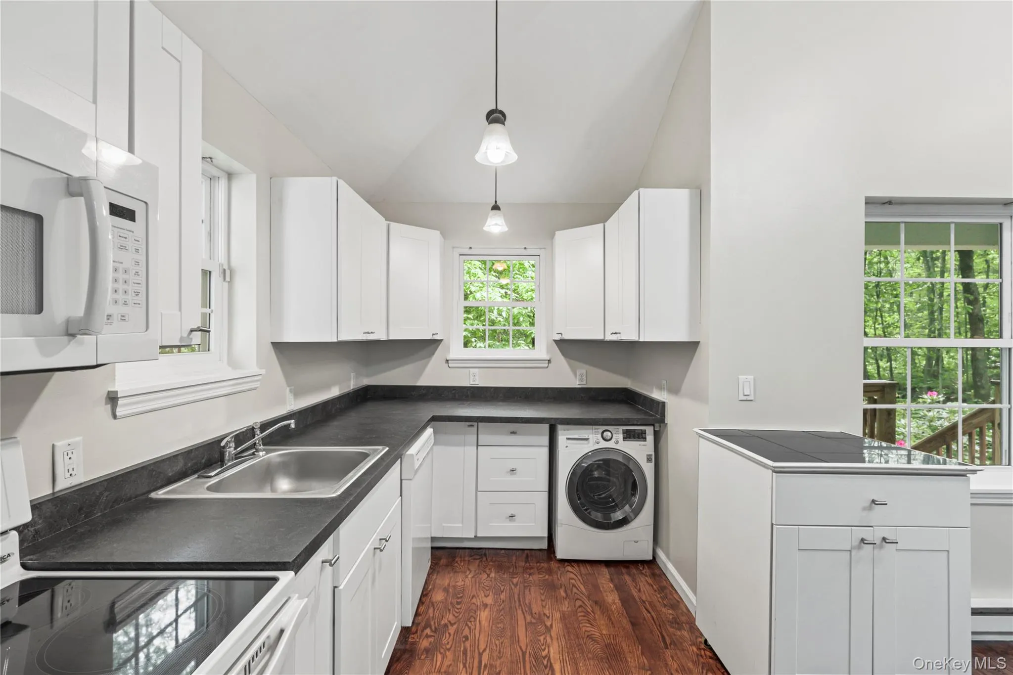 Alternate view of the kitchen with a brand new ventless combination washer/dryer LG unit. Alternate view of the kitchen with a brand new ventless combination washer/dryer LG unit.