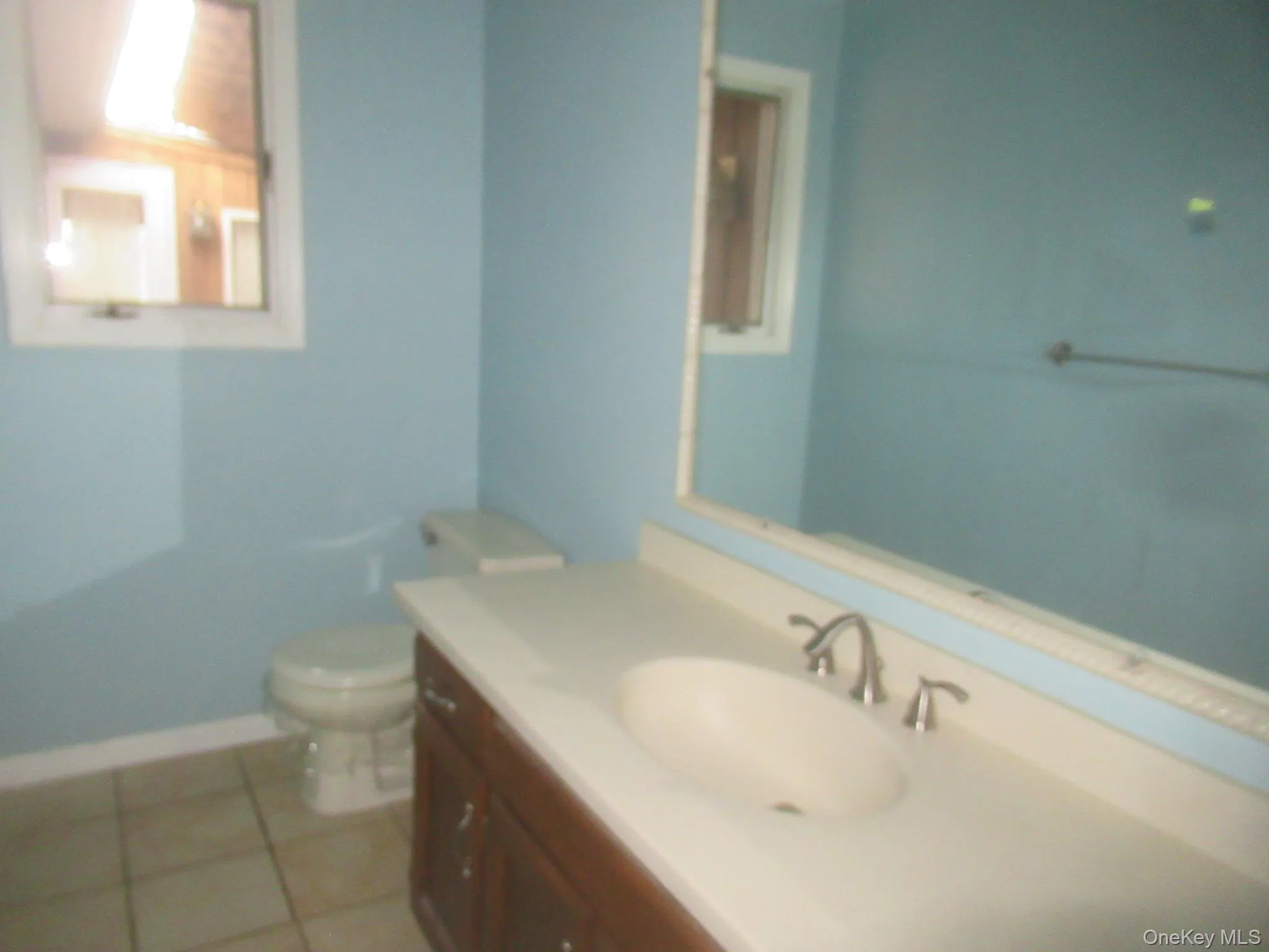 Bathroom with vanity and light tile patterned floors Bathroom with vanity and light tile patterned floors