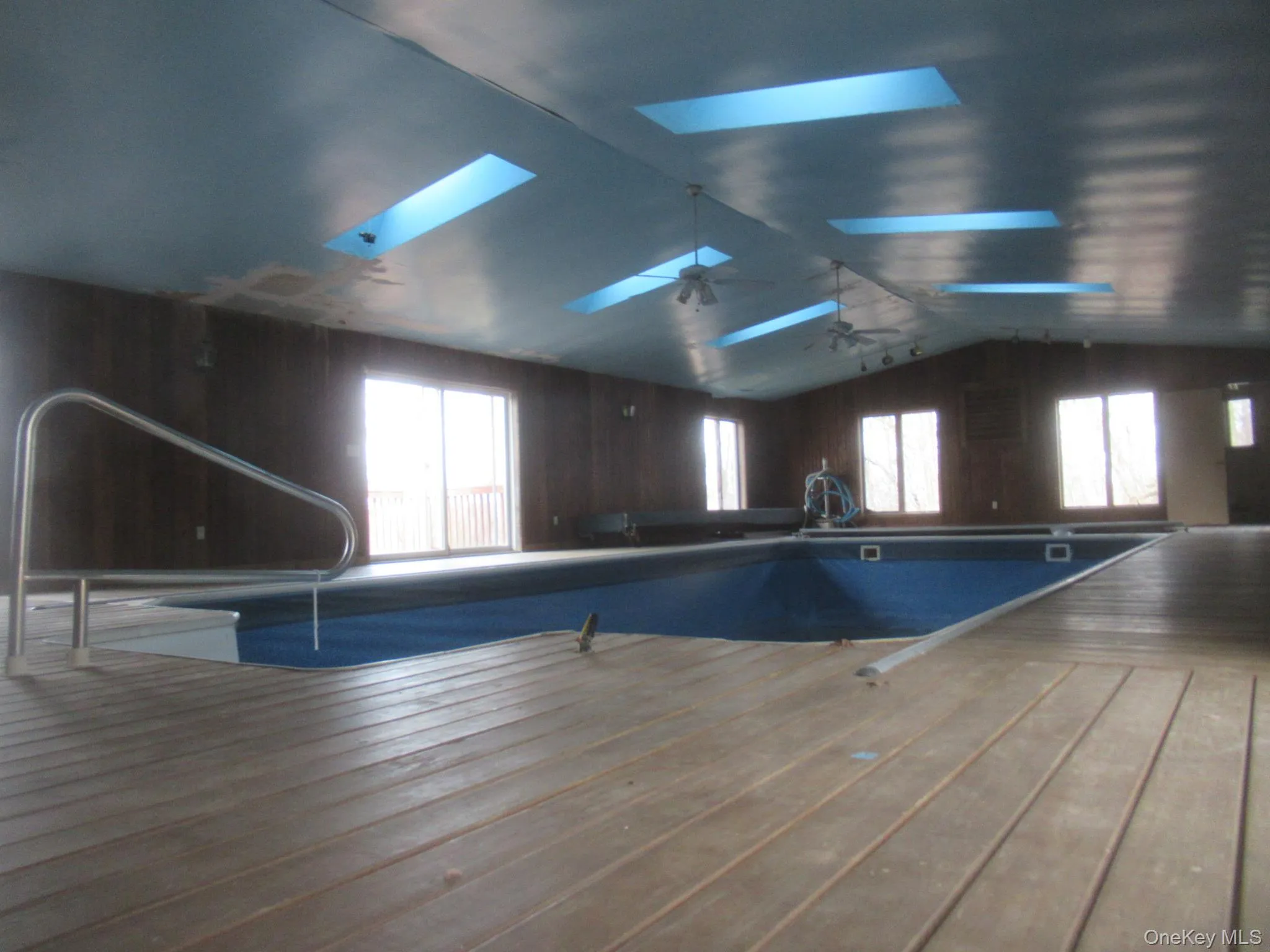 View of pool featuring a skylight View of pool featuring a skylight