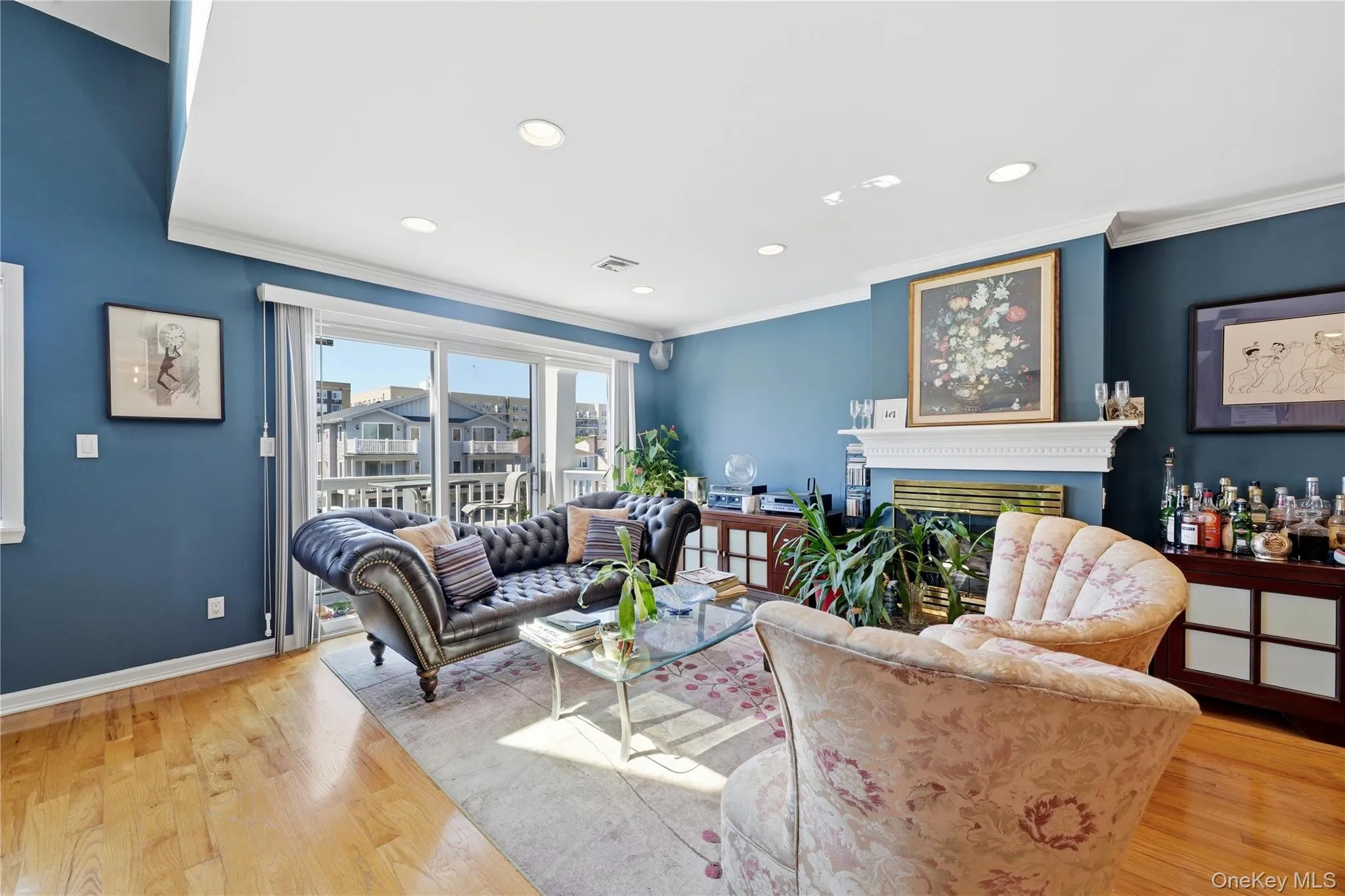 Open-concept living and dining area with hardwood floors, gas fireplace, access to a private south-facing terrace, recessed lighting, high ceilings, and beautiful natural light throughout Open-concept living and dining area with hardwood floors, gas fireplace, access to a private south-facing terrace, recessed lighting, high ceilings, and beautiful natural light throughout