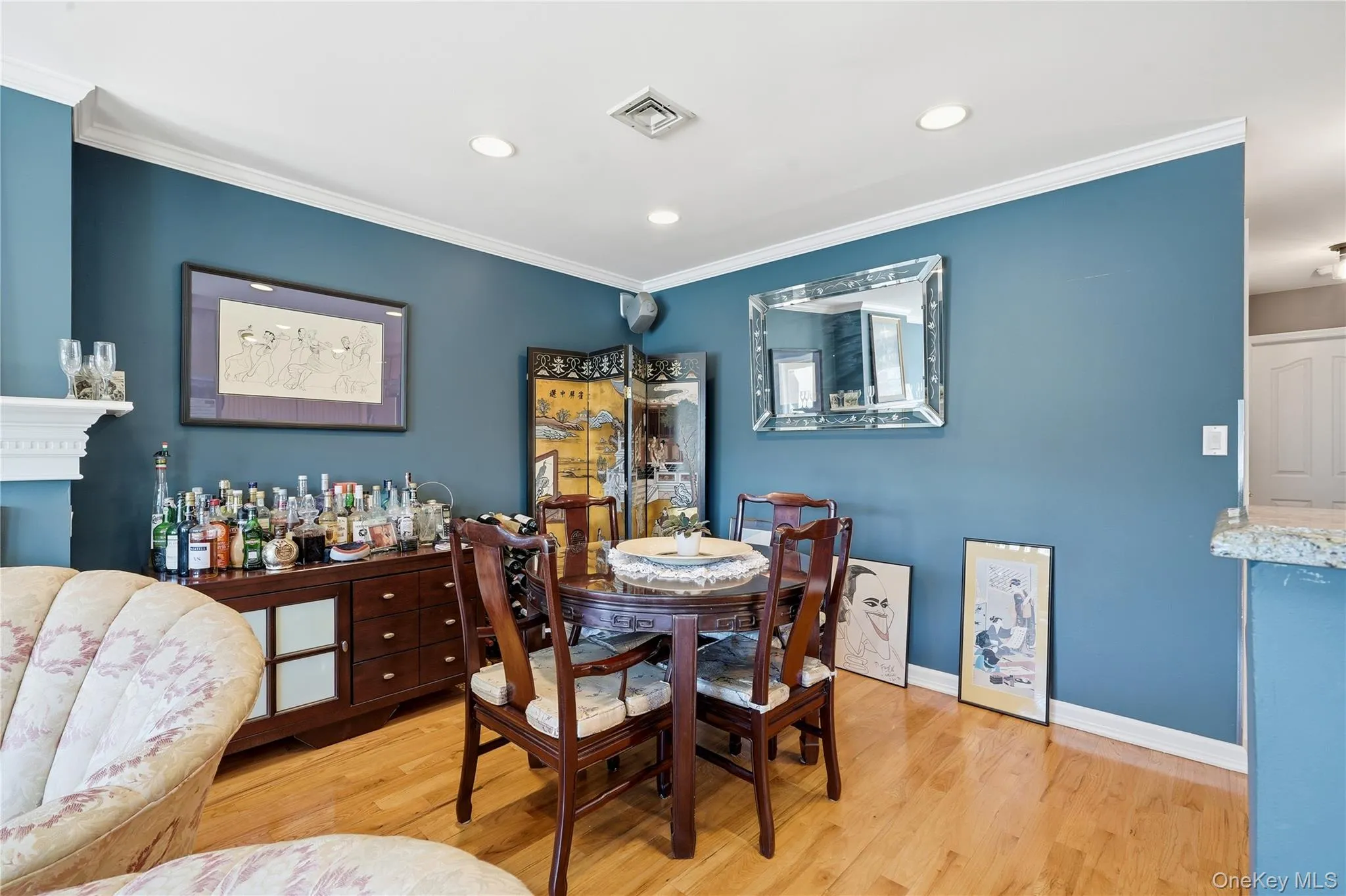 Dining area with hardwood floors, recessed lighting, crown molding, and an open flow to the living room and kitchen Dining area with hardwood floors, recessed lighting, crown molding, and an open flow to the living room and kitchen