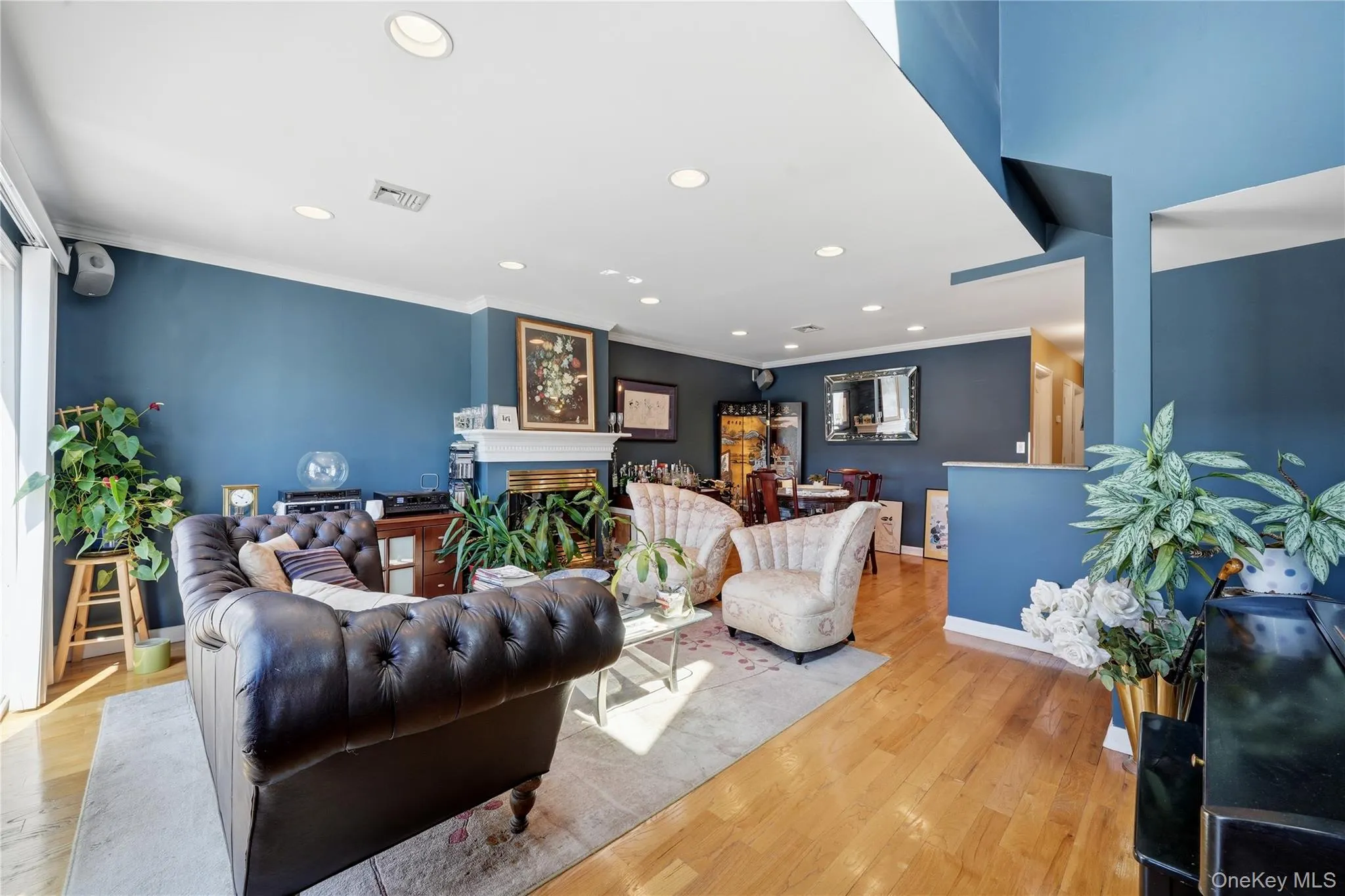 Open-concept living and dining area with hardwood floors, gas fireplace, access to a private south-facing terrace, recessed lighting, high ceilings, and beautiful natural light throughout Open-concept living and dining area with hardwood floors, gas fireplace, access to a private south-facing terrace, recessed lighting, high ceilings, and beautiful natural light throughout