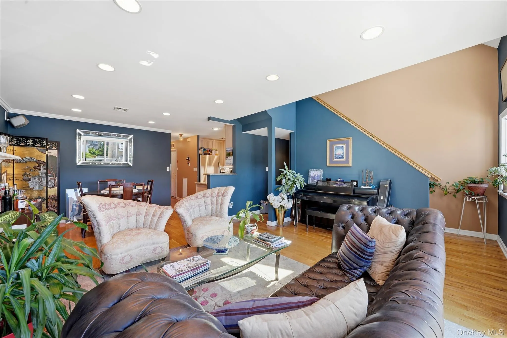 Open-concept living and dining area with hardwood floors, gas fireplace, access to a private south-facing terrace, recessed lighting, high ceilings, and beautiful natural light throughout Open-concept living and dining area with hardwood floors, gas fireplace, access to a private south-facing terrace, recessed lighting, high ceilings, and beautiful natural light throughout
