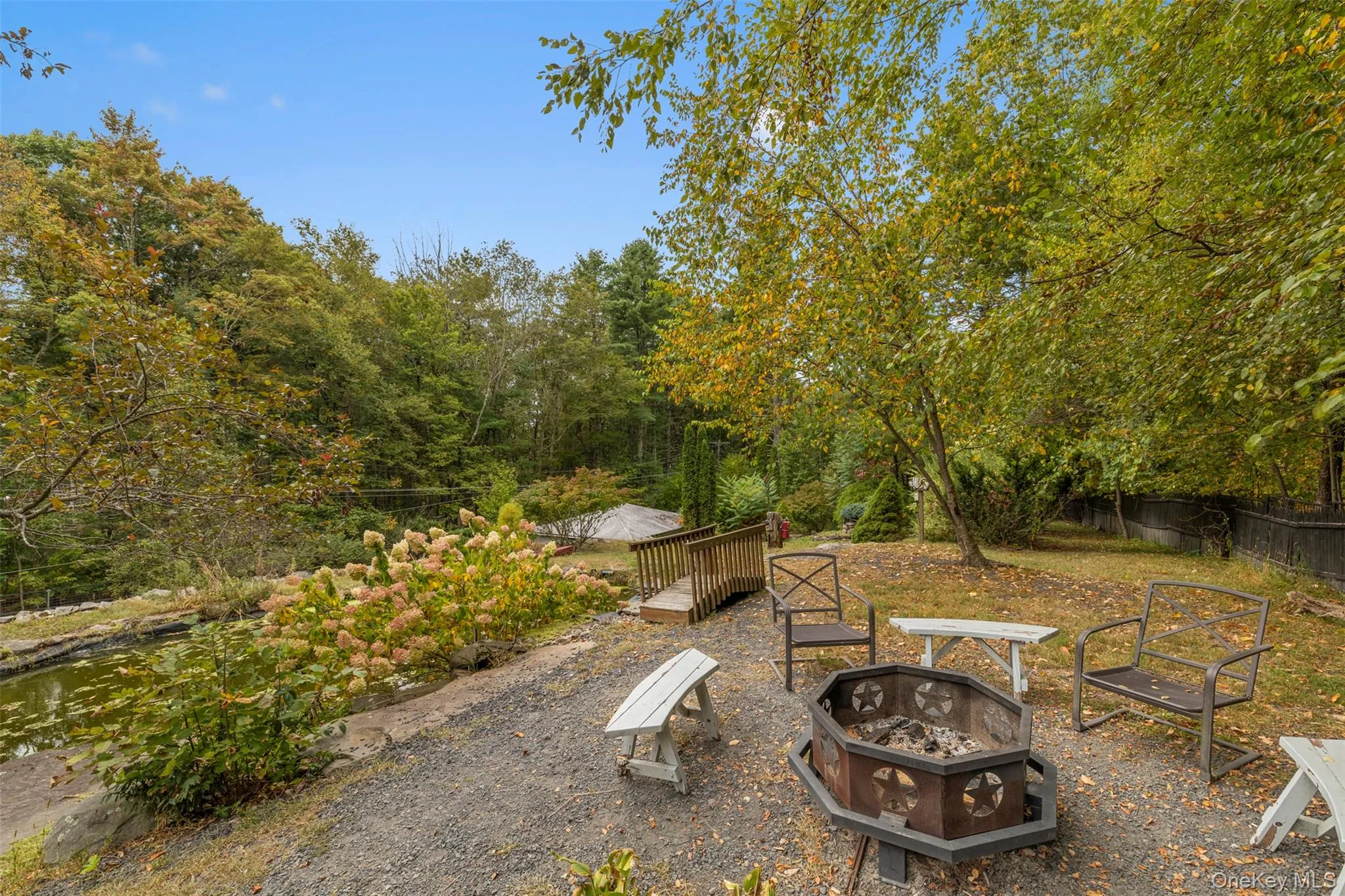 View of yard with a fire pit View of yard with a fire pit
