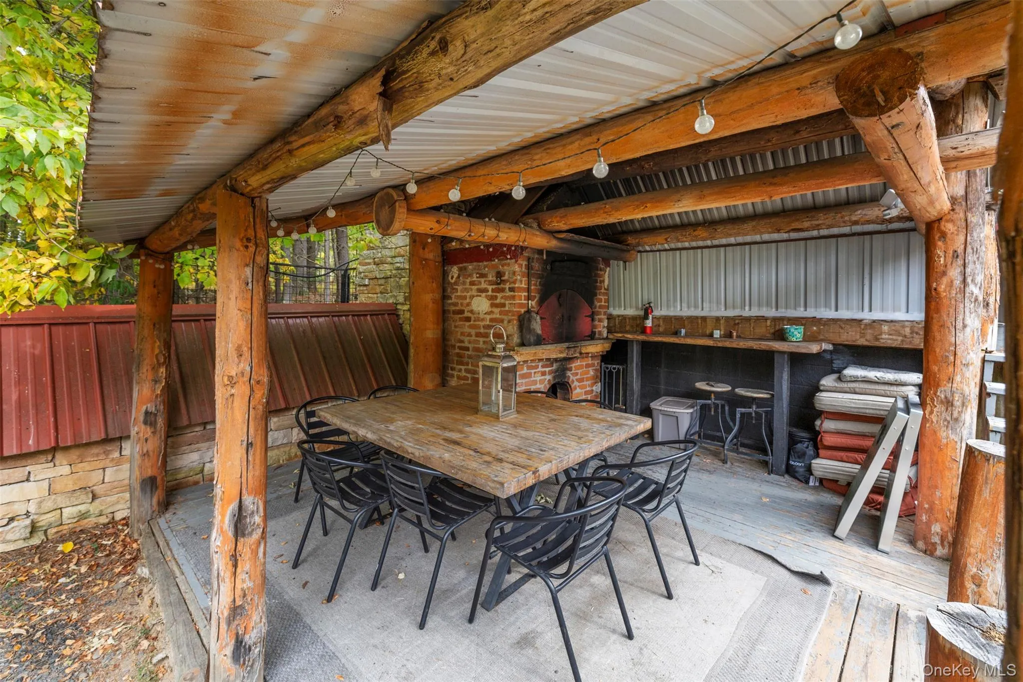 View of patio with outdoor dining space and a fireplace View of patio with outdoor dining space and a fireplace