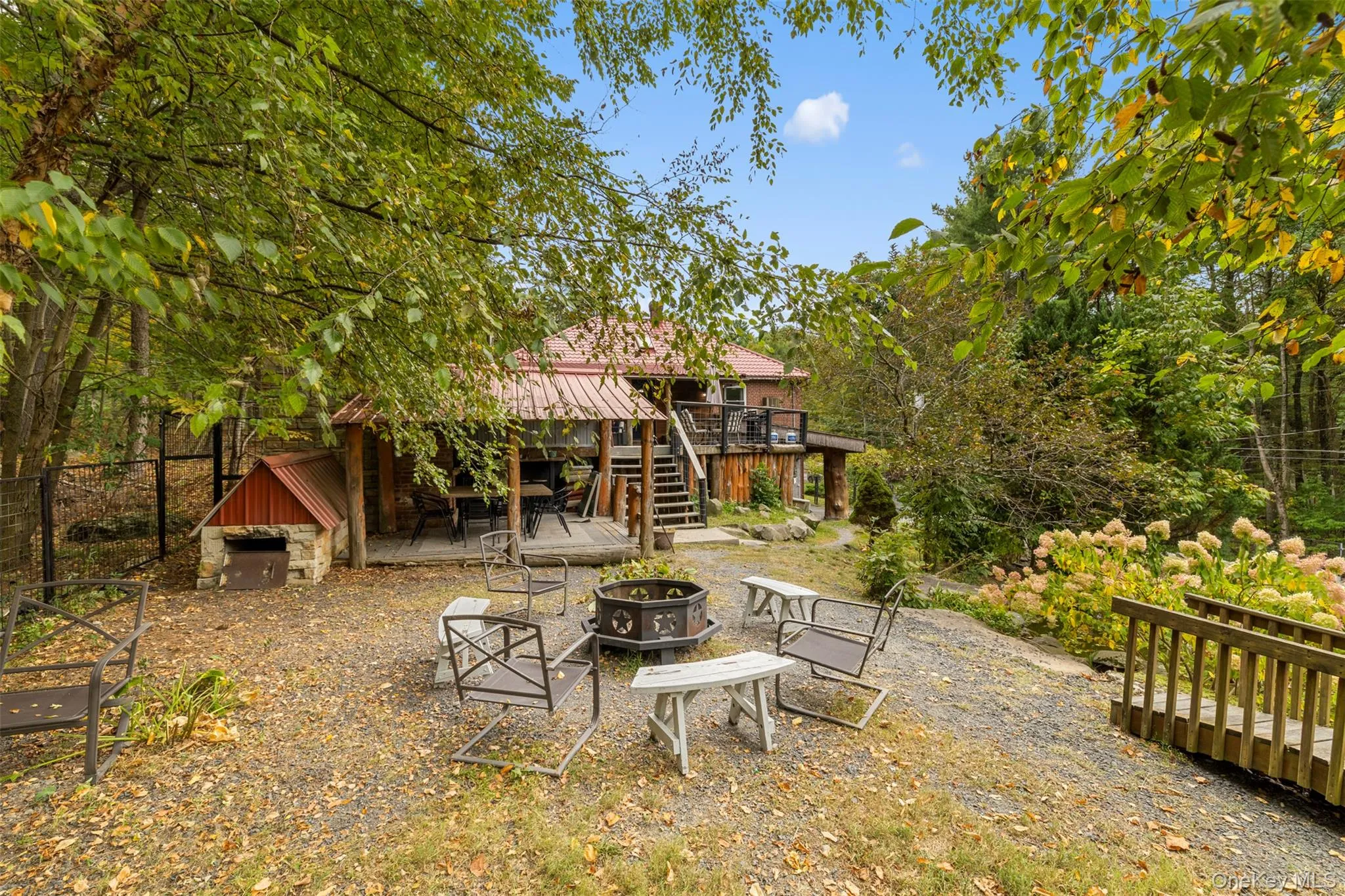 View of yard featuring a fire pit, stairs, a patio, and a deck View of yard featuring a fire pit, stairs, a patio, and a deck